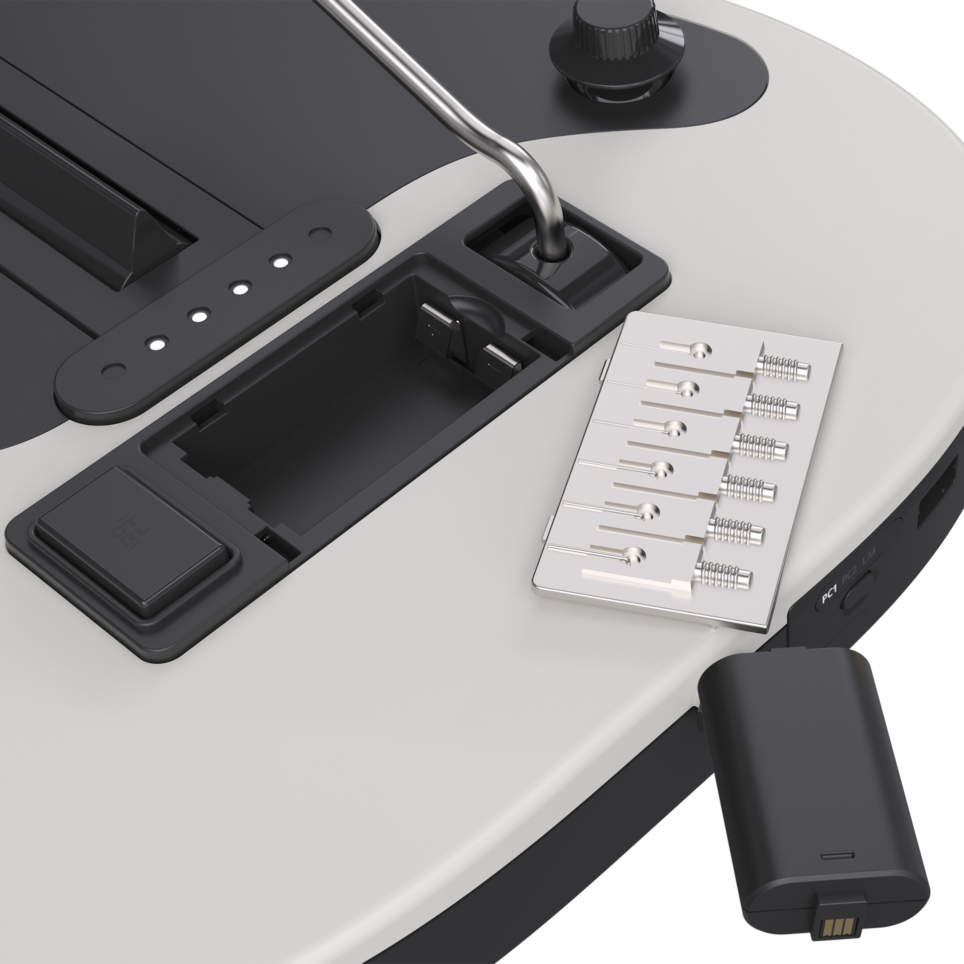 Nahaufnahme einer weißen und schwarzen Konsole mit offenem Batteriefach, Metallteilen und einem USB-Stick.