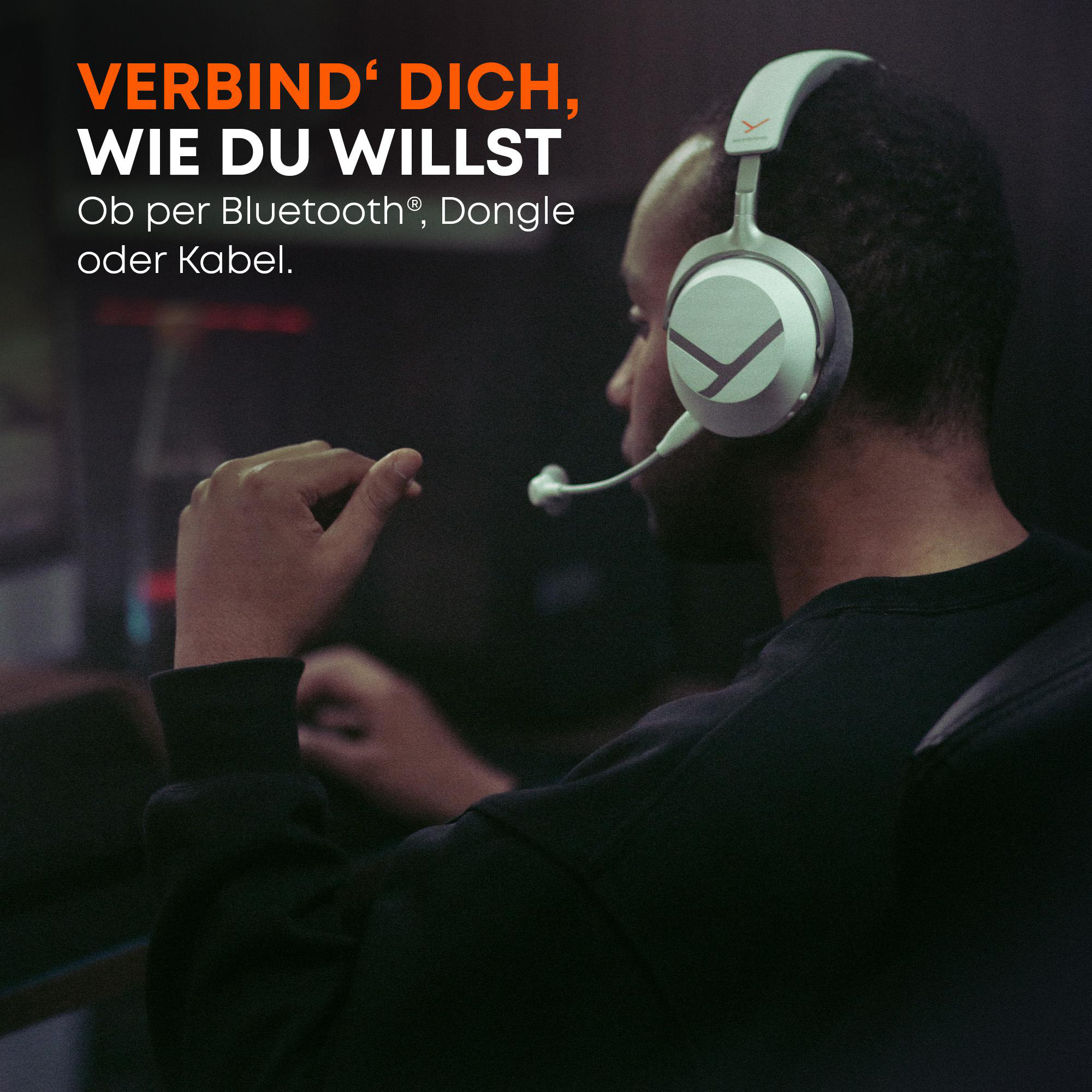 Ein Mann mit weißen Gaming-Kopfhörern und Mikrofon in einem abgedunkelten Raum mit deutschem Werbetext.