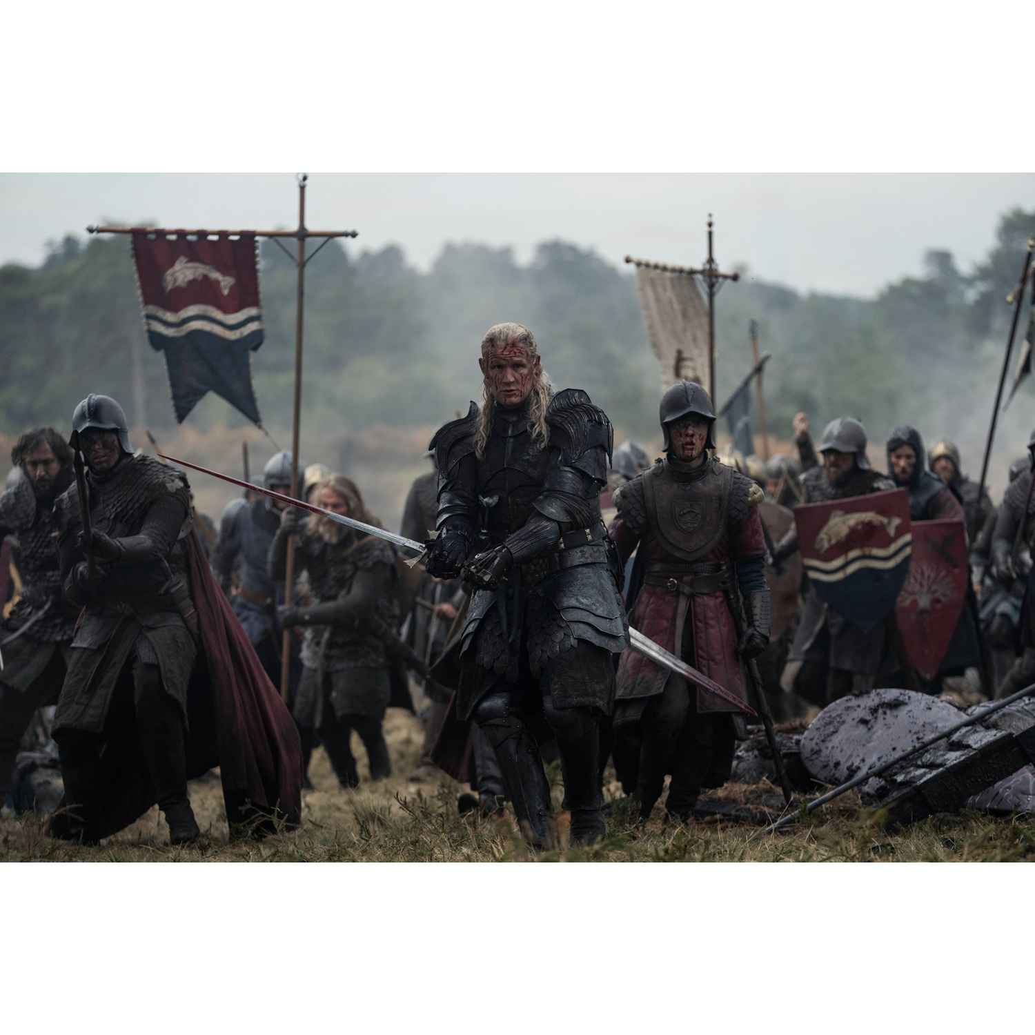 A medieval army in armor on a battlefield, led by a central warrior holding a bloodied sword, with banners flying.