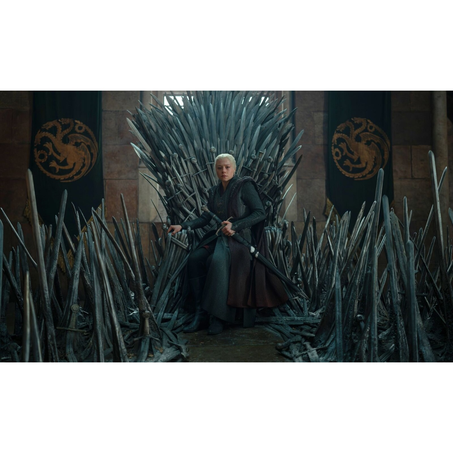 A blonde woman sits on a large throne made of swords, with banners hanging in the background.