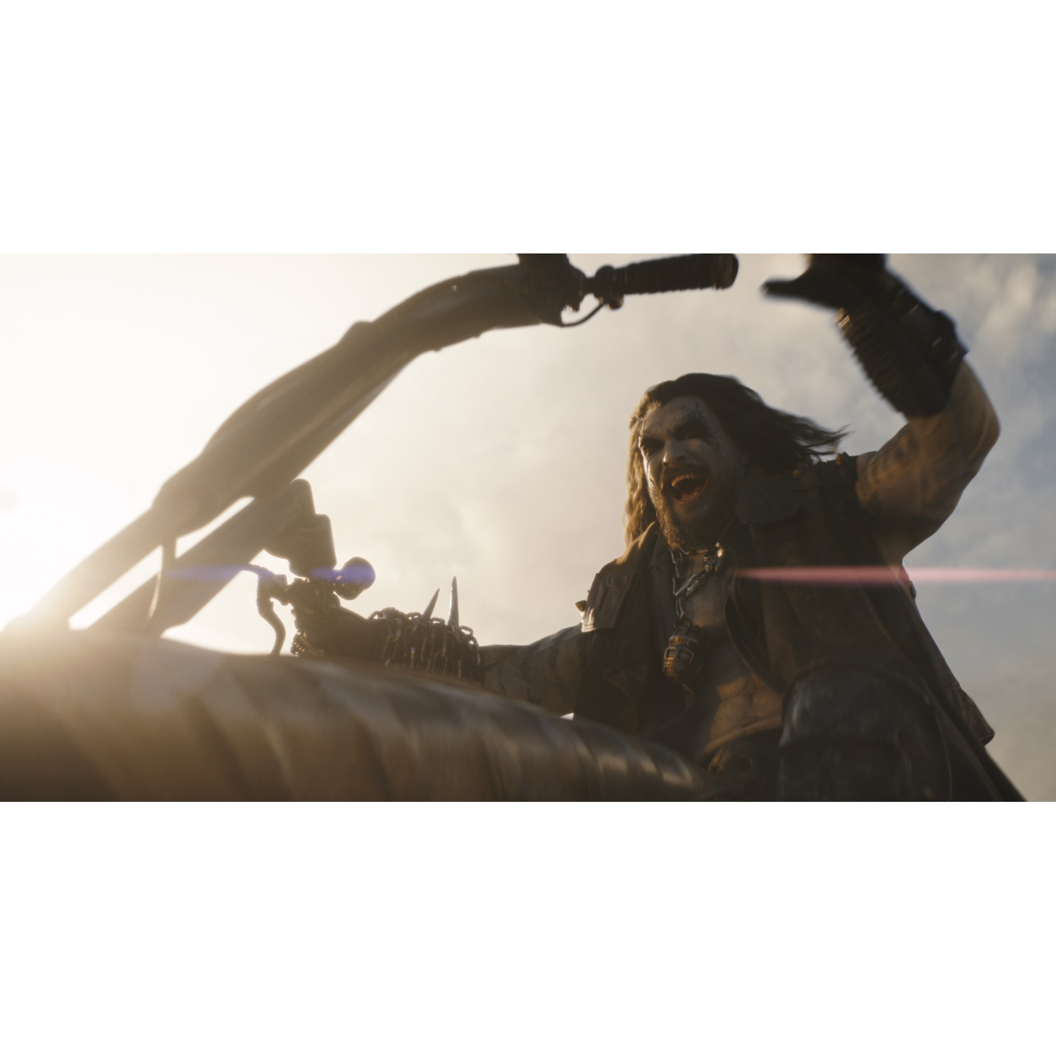 A wild man with long hair rides a motorcycle and screams with joy.