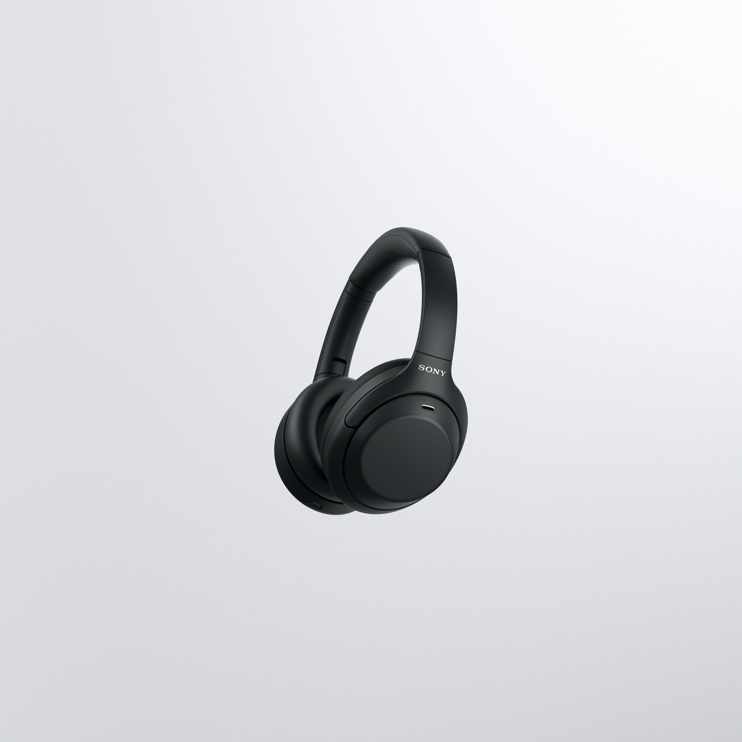 Black Sony over-ear headphones centered against a plain, bright background.