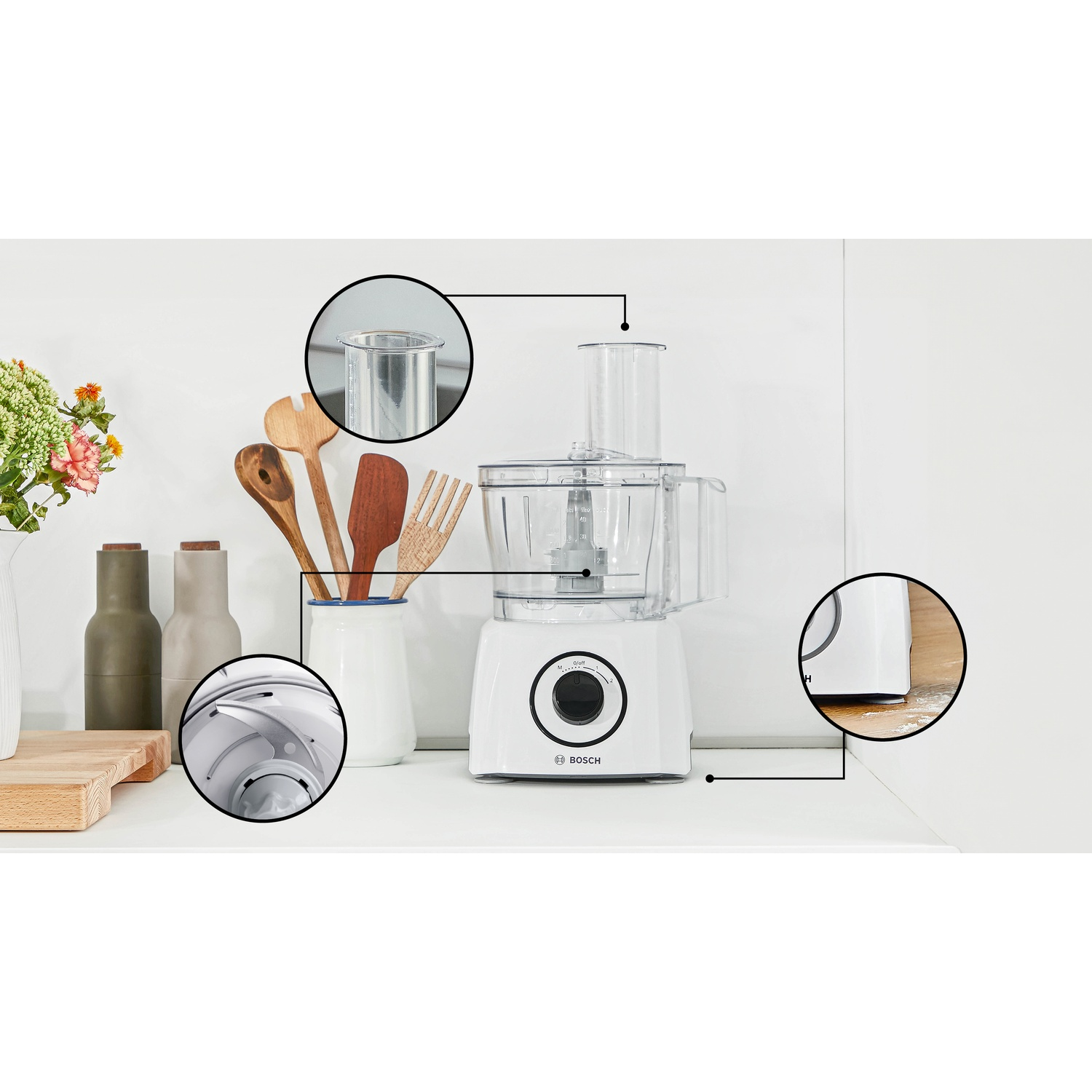 Un robot da cucina bianco Bosch su un ripiano con cerchi che mostrano dettagli ingranditi.