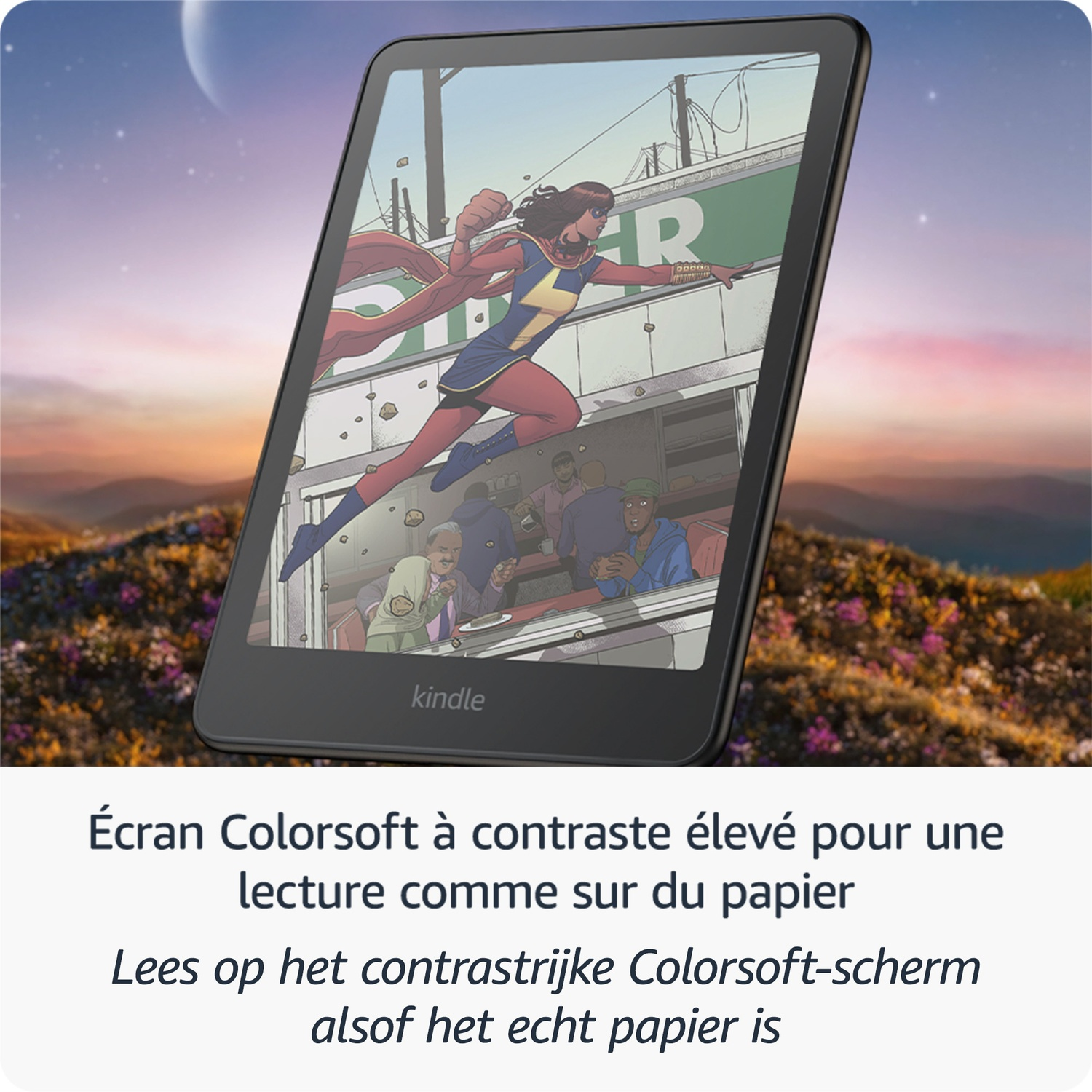 Une liseuse Kindle affiche une page de bande dessinée en couleur devant un paysage pittoresque au coucher du soleil.