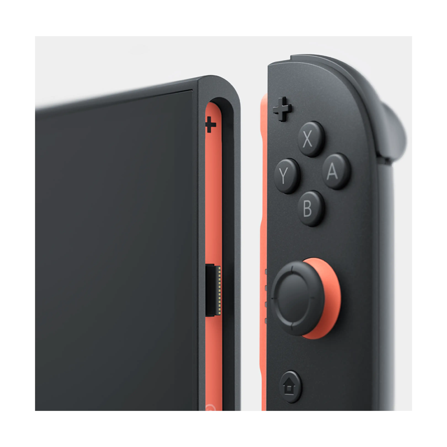 Primer plano de una consola Nintendo Switch y su mando gris Joy-Con desmontable sobre un fondo claro.