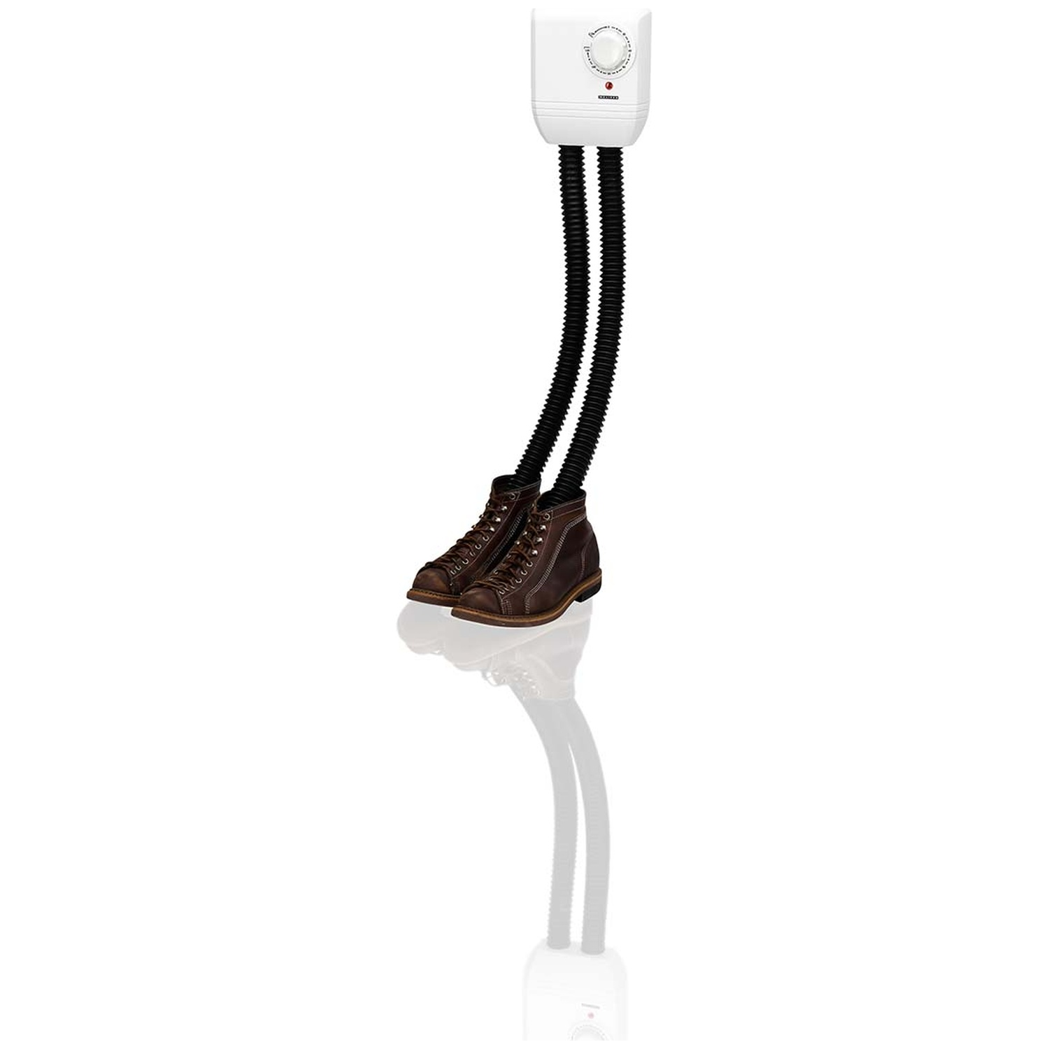 A white wall-mounted boot dryer with two black corrugated hoses connected to a pair of brown leather boots.
