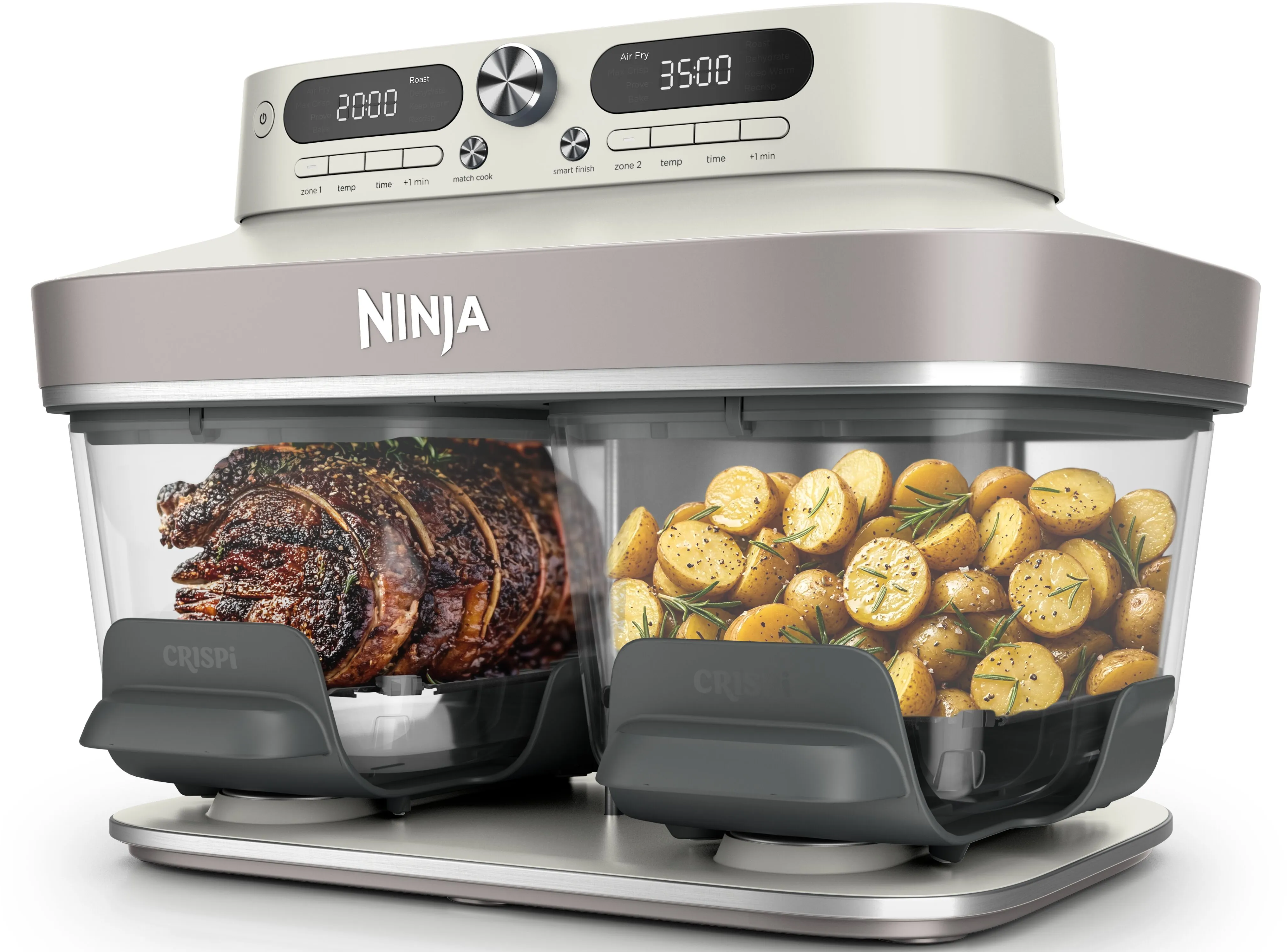 Eine Ninja-Heißluftfritteuse mit zwei durchsichtigen Schubladen: links ein Braten, rechts gewürzte Kartoffeln.