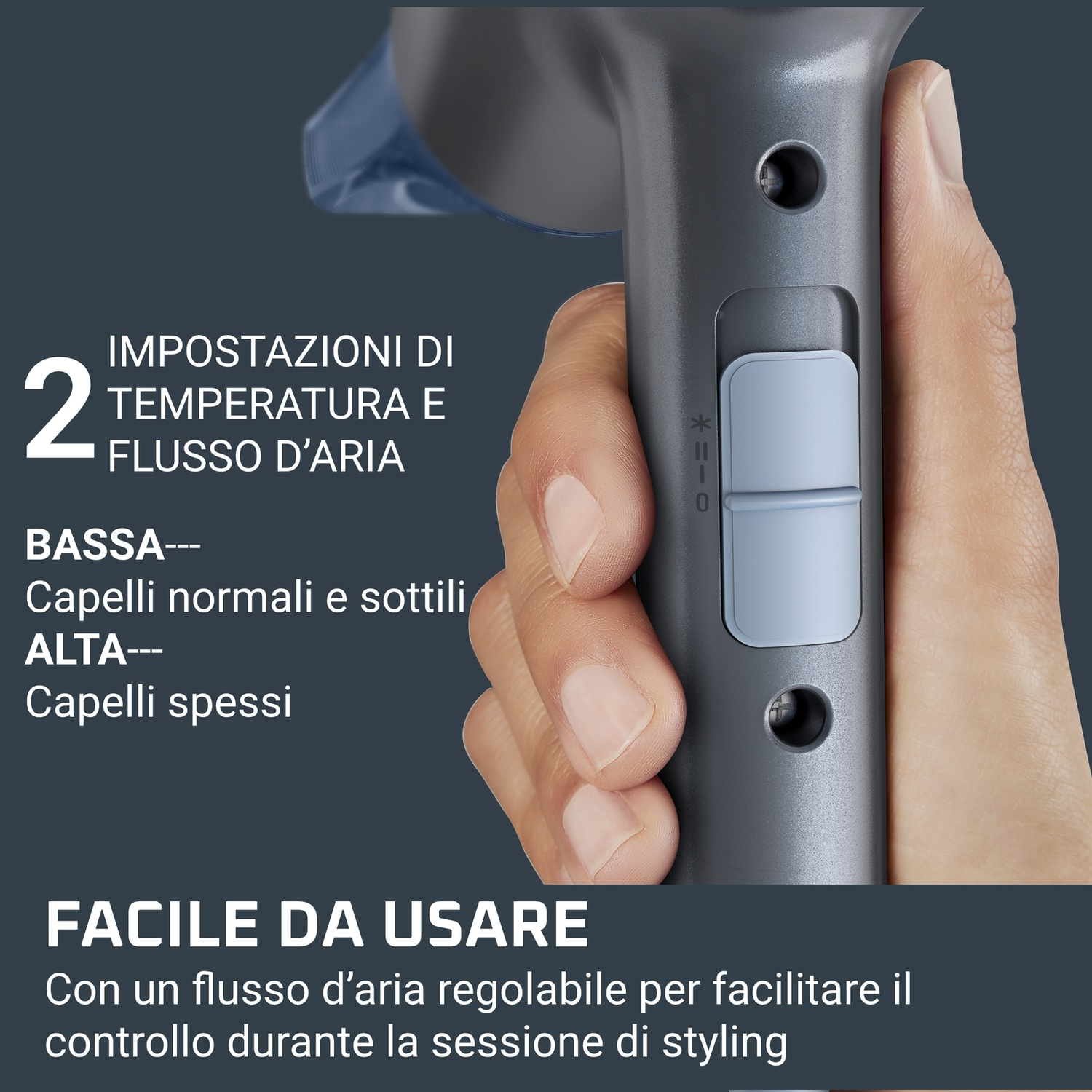Una mano tiene un asciugacapelli grigio, mostrando l'interruttore a due velocità.