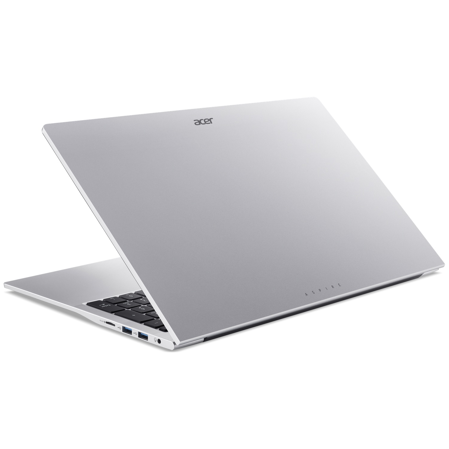 Un ordinateur portable Acer Aspire argenté repose sur une surface blanche, montrant ses ports.
