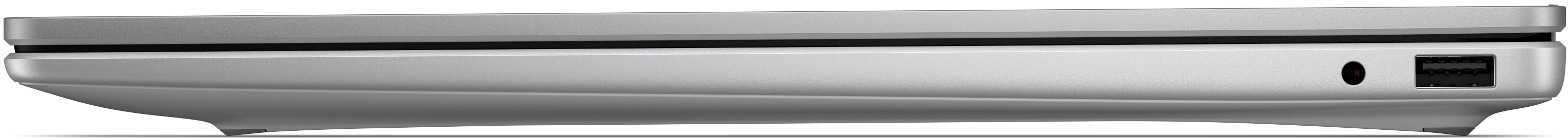 Zárt, ezüstszínű laptop oldalsó profilja egy USB-porttal és egy audio-csatlakozóval.