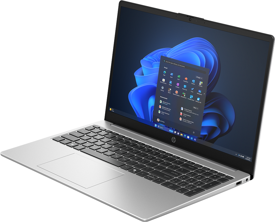 Egy ezüst laptop fekete billentyűzettel és kék Windows háttérképpel a képernyőn.