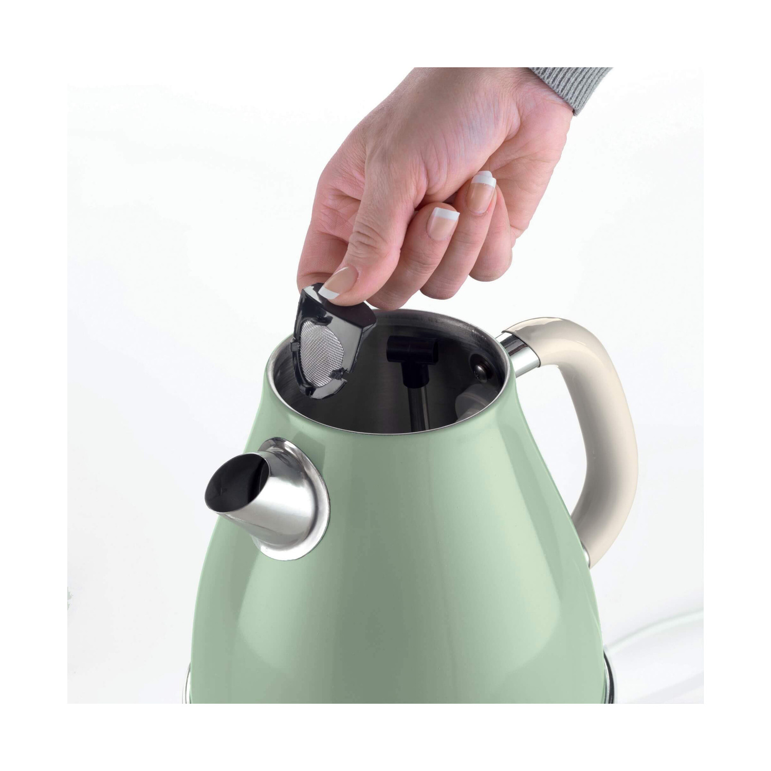 Una mano inserisce un filtro in un bollitore verde.