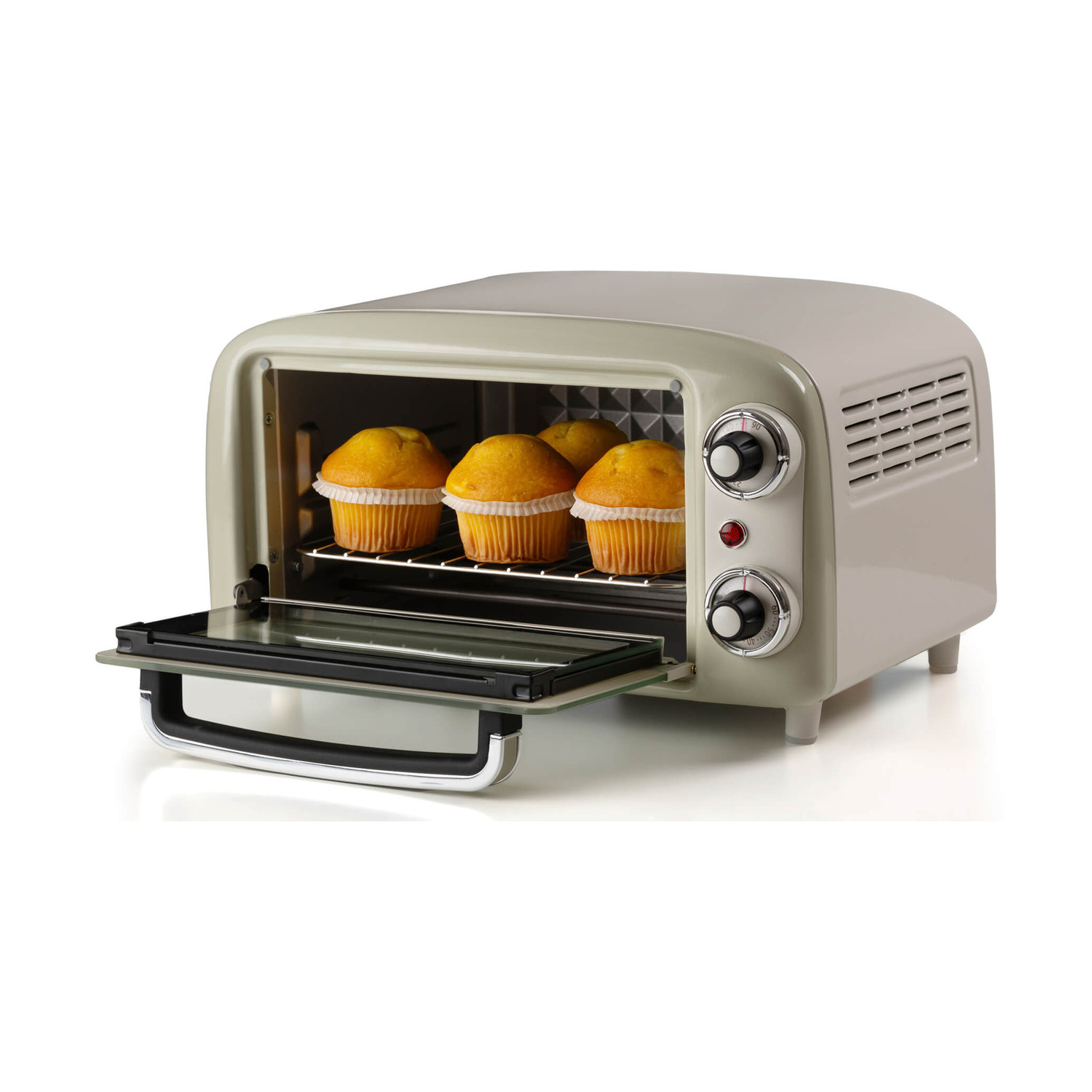 Un mini forno beige con la porta in vetro aperta contiene quattro muffin su una griglia.