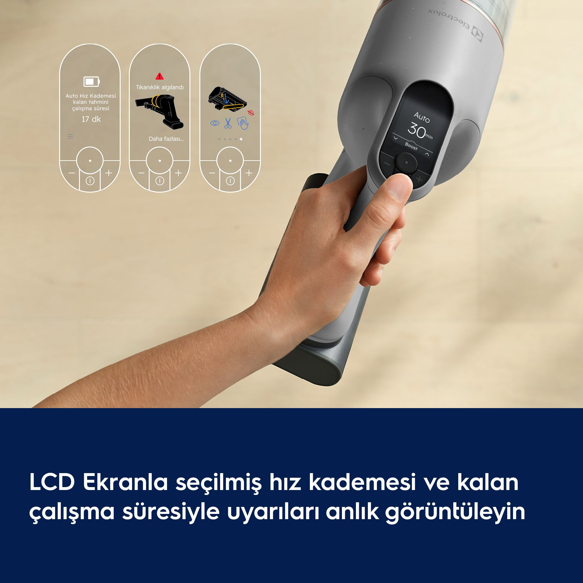 Eldeki gri elektrikli süpürgenin LCD ekranı ve üzerinde işlev simgeleri görünüyor.