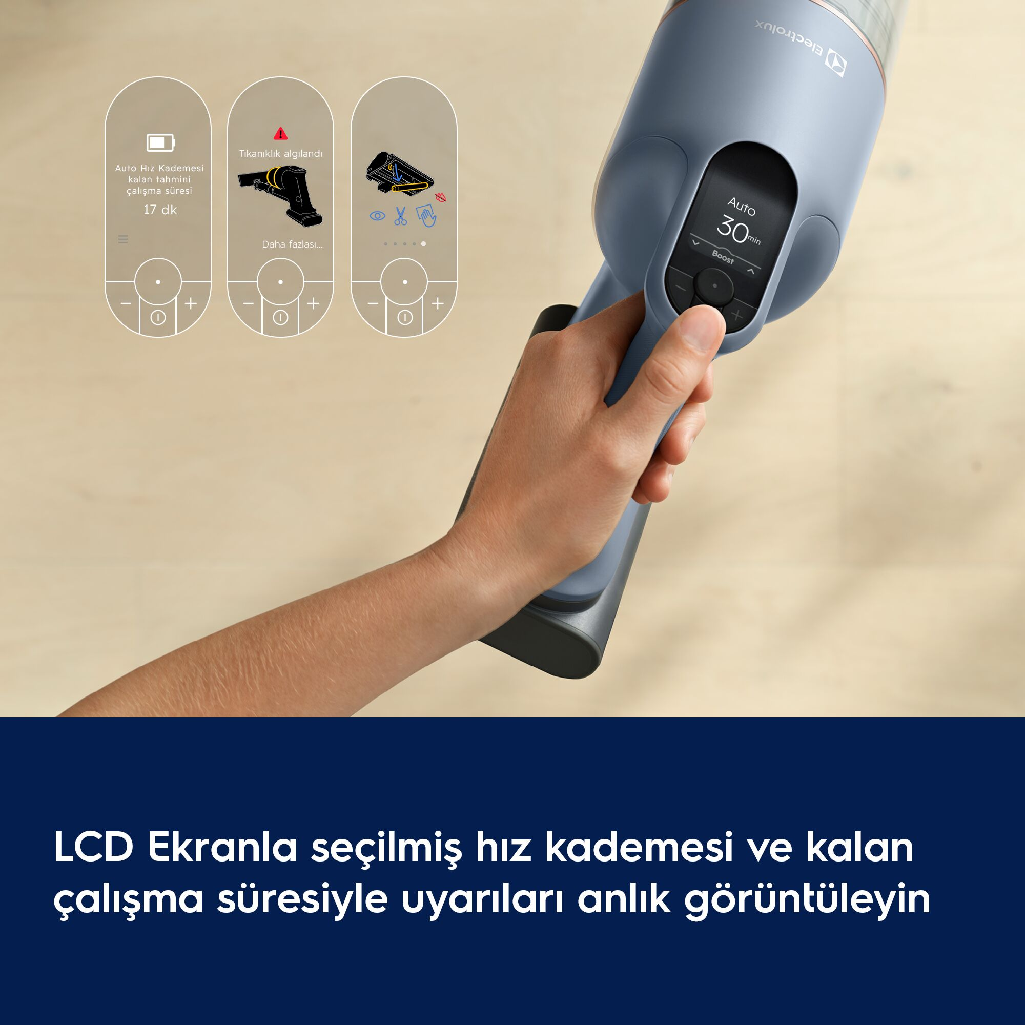 LCD ekranlı ve grafikli mavi şarjlı süpürgeyi tutan bir el.