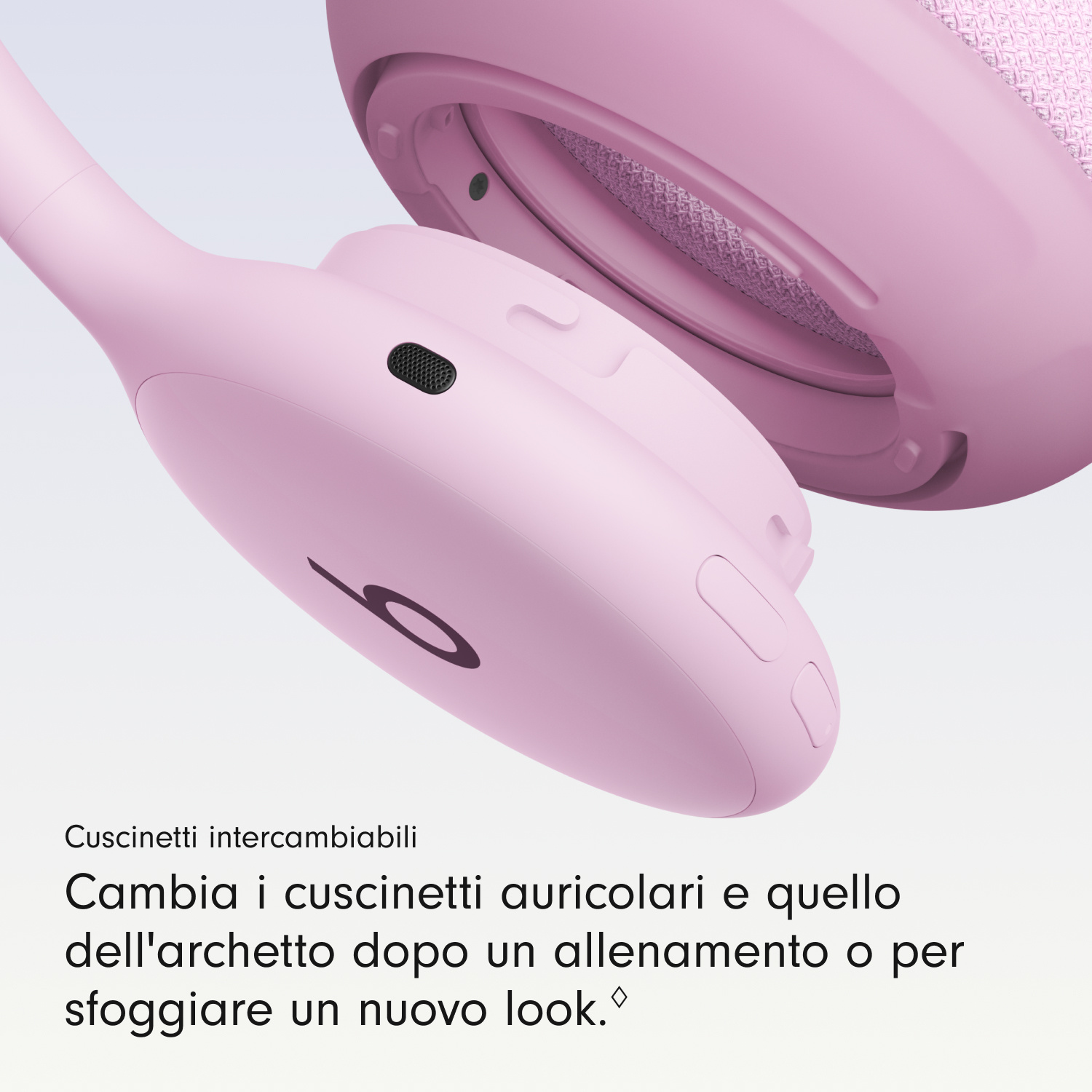 Primo piano di cuffie wireless rosa con cuscinetti intercambiabili su sfondo chiaro e testo in basso.