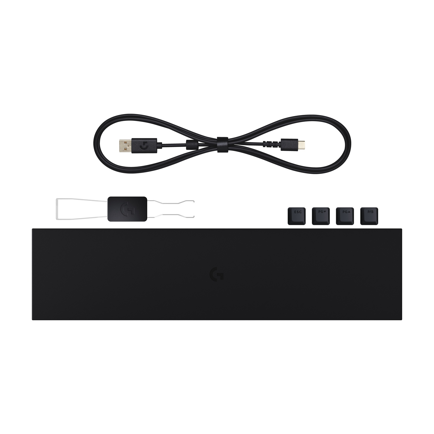 Cavo USB nero, estrattore di tasti, quattro tasti extra e un tappetino piatto su sfondo bianco.