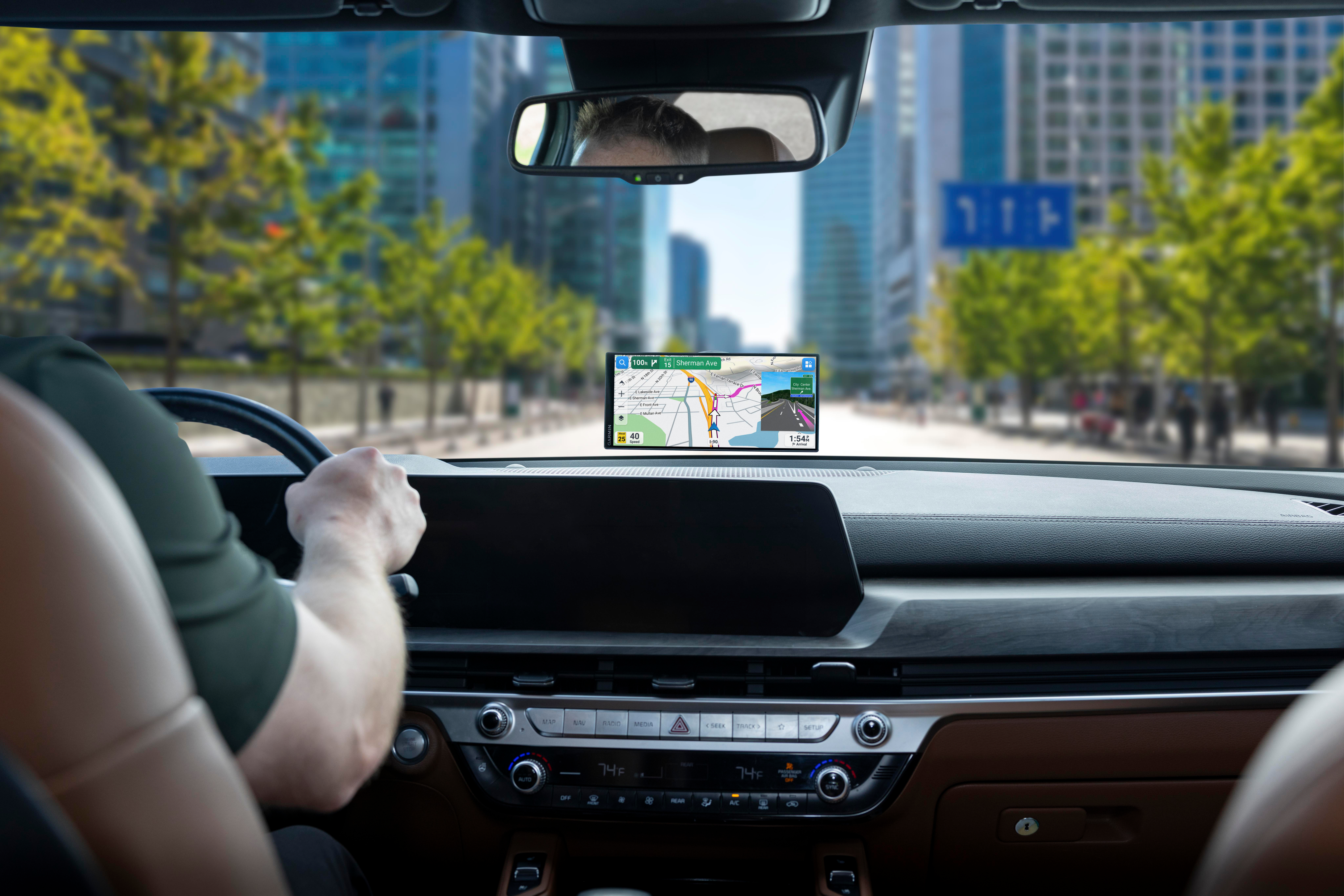 Fahrer im Auto mit GPS-Navigation auf der Straße vor Stadtgebäuden.