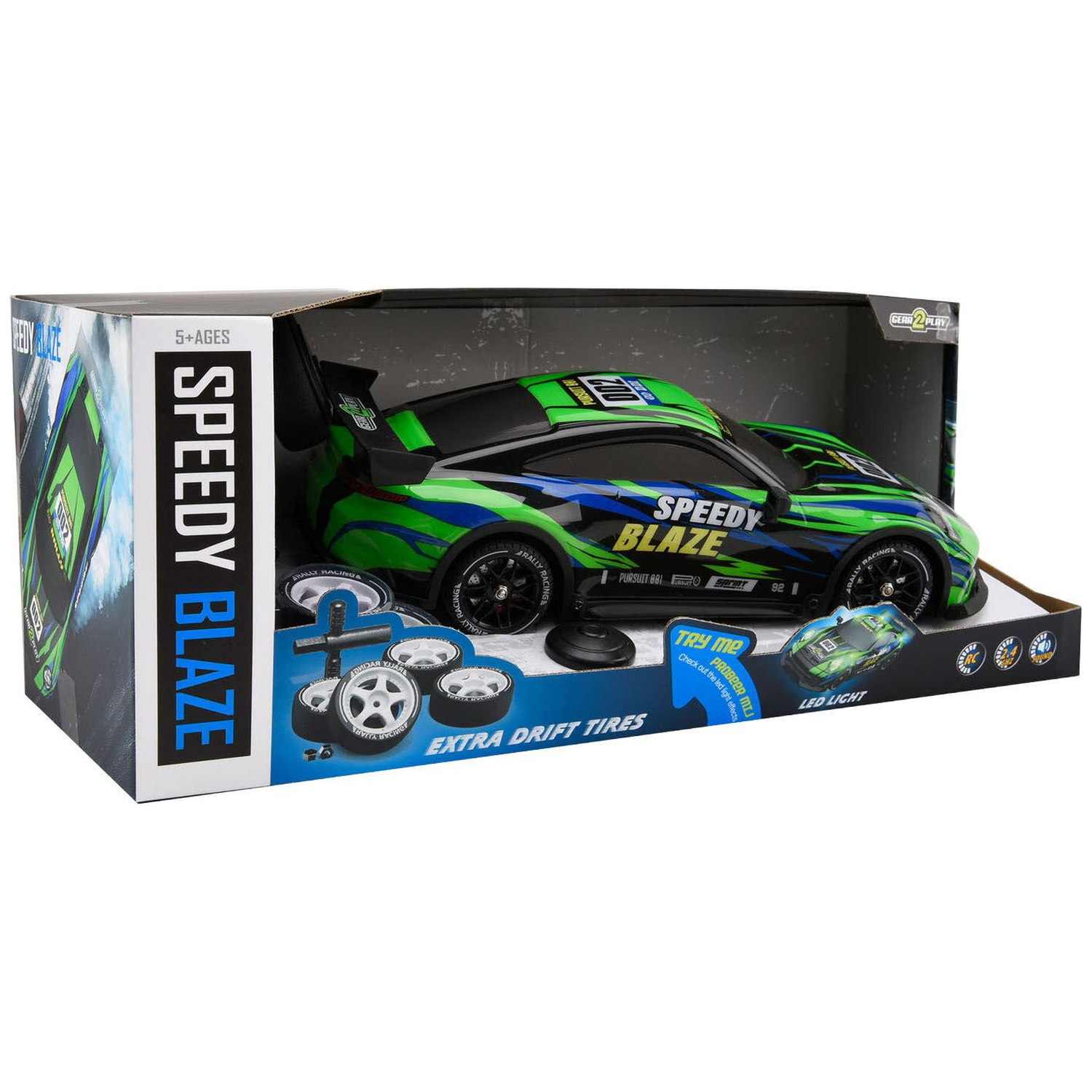 A black, green, and blue Speedy Blaze RC drift car inside its packaging box with extra tires.