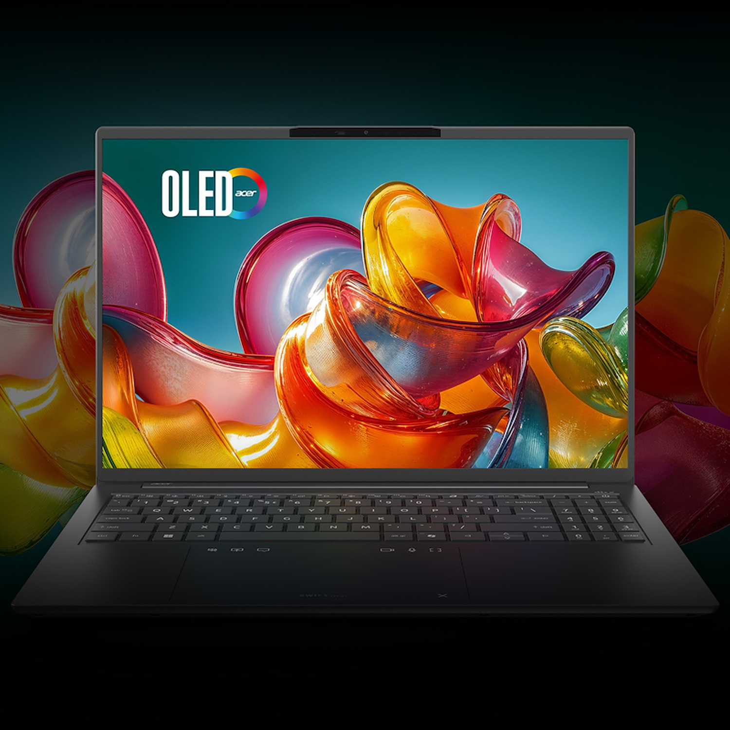 Un computer portatile nero aperto con uno schermo OLED astratto e vibrante su sfondo scuro.