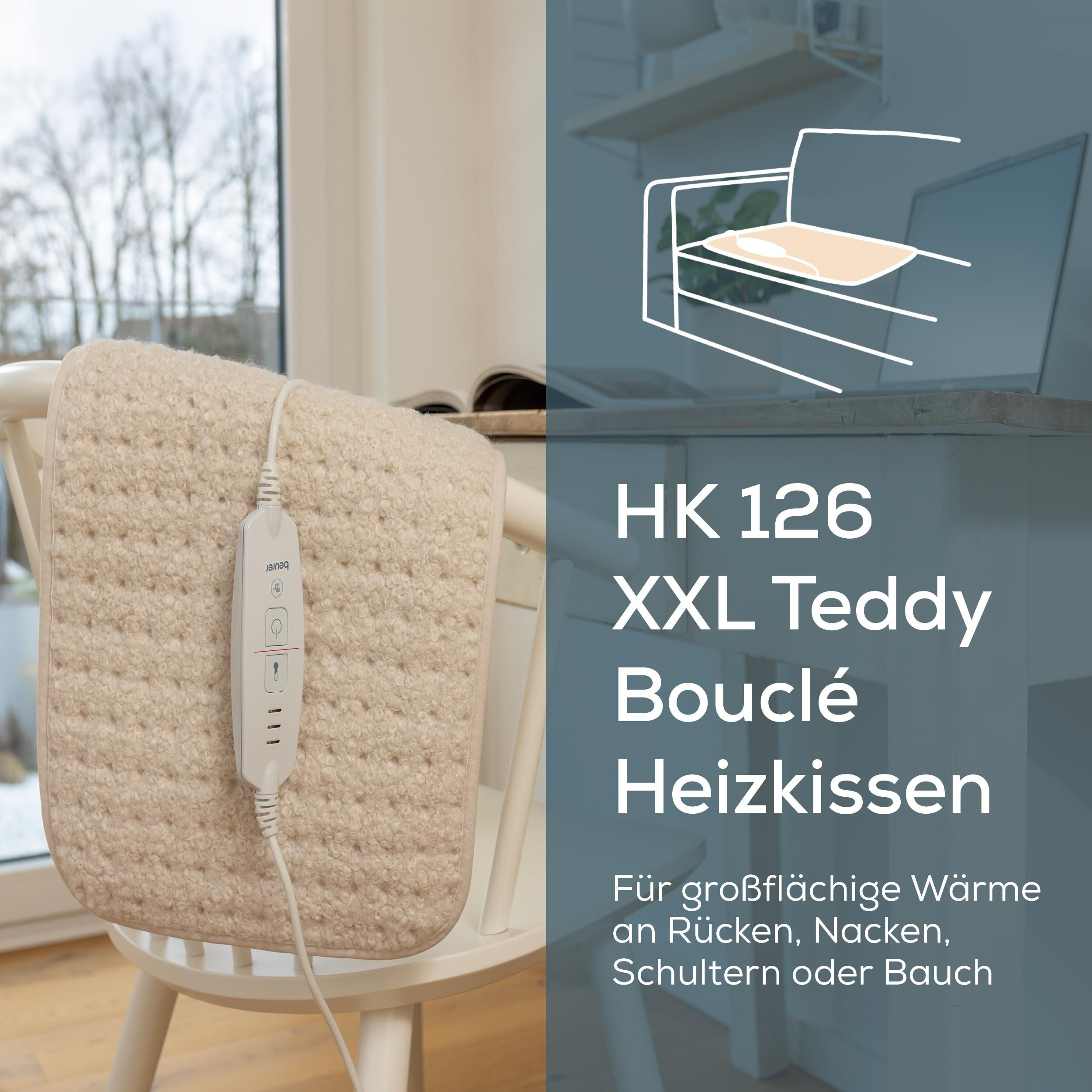 Beurer HK 126 XXL Teddy Bouclé Heizkissen auf einem weißen Stuhl mit weißem Bedienteil.
