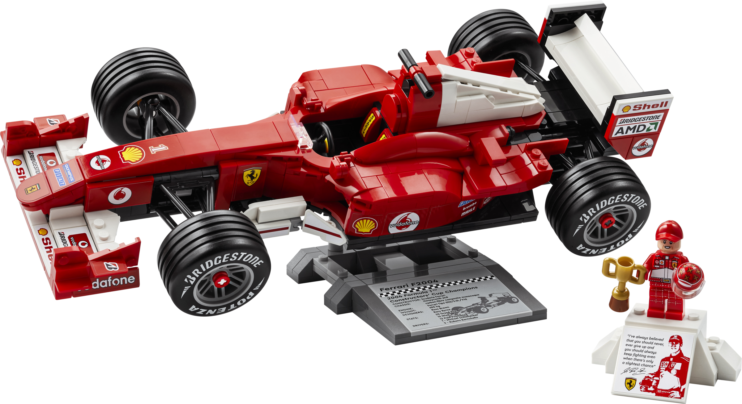 Rotes Lego Ferrari F2004 Rennauto auf einem Ständer mit einer Minifigur, die eine Trophäe hält.