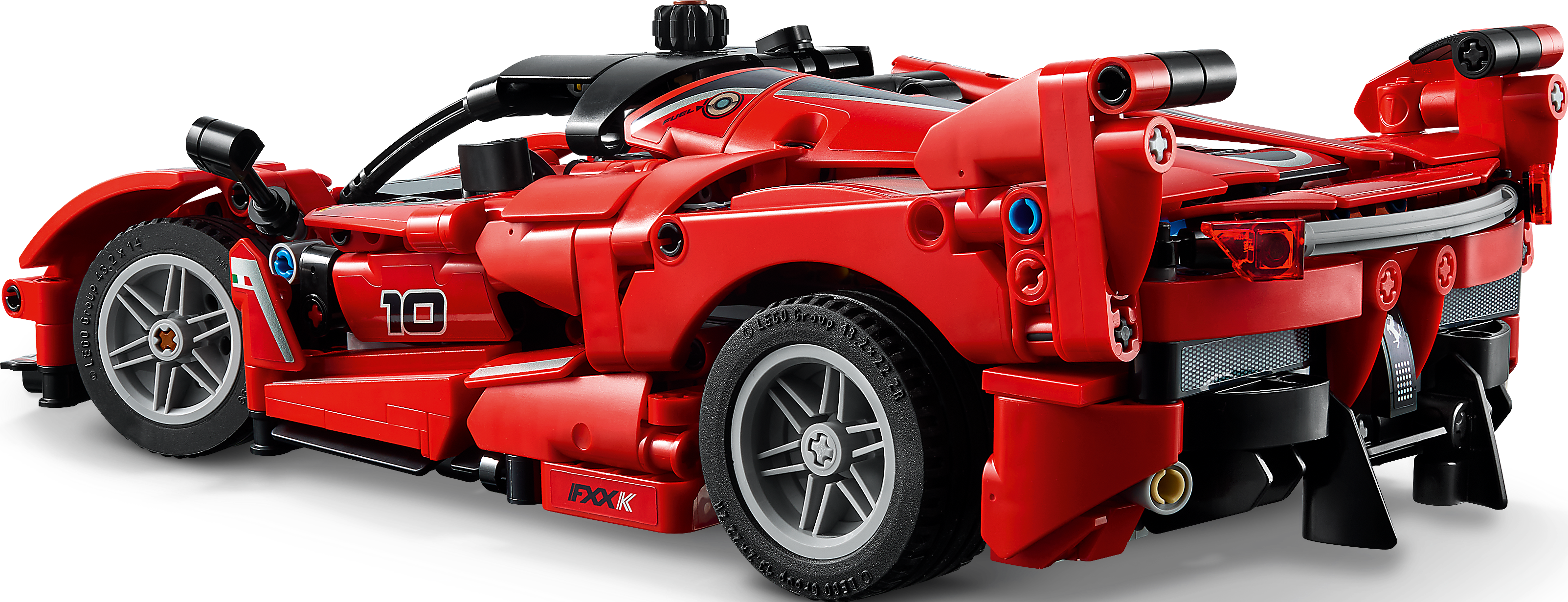 Une voiture jouet Lego Technic Ferrari rouge sur fond noir, avec roues et détails visibles.