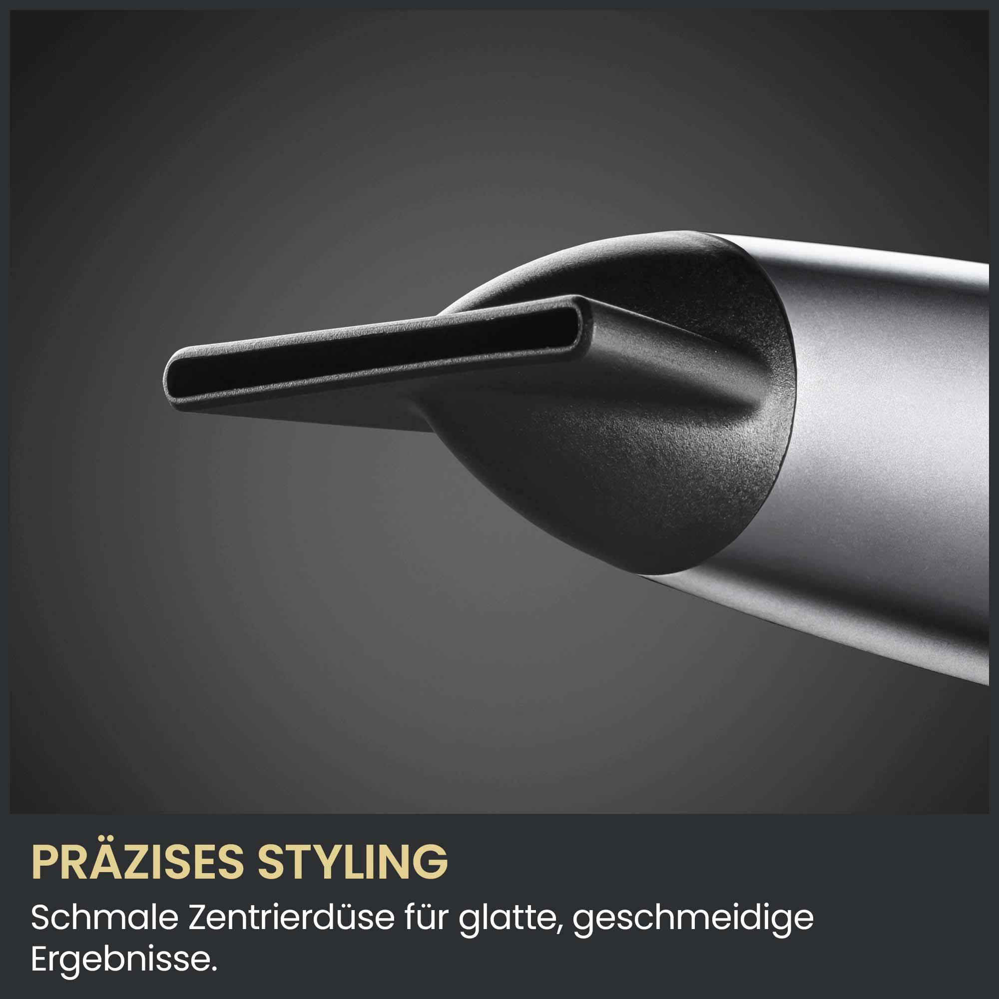 Nahaufnahme einer schmalen schwarzen Styling-Düse für Haartrockner vor dunklem Hintergrund.
