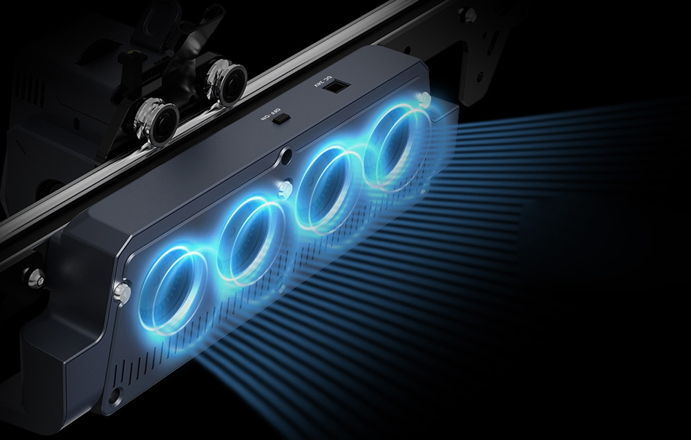 Fekete műszaki eszköz négy kör alakú, kék ragyogó gyűrűvel, amely kék fénysugarakat bocsát ki.