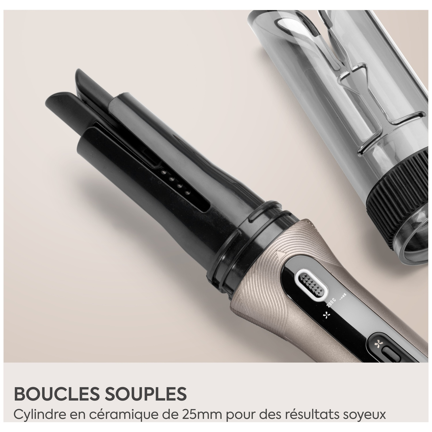 Boucleur automatique beige avec cylindre en céramique noire et capuchon protecteur transparent sur fond beige clair.