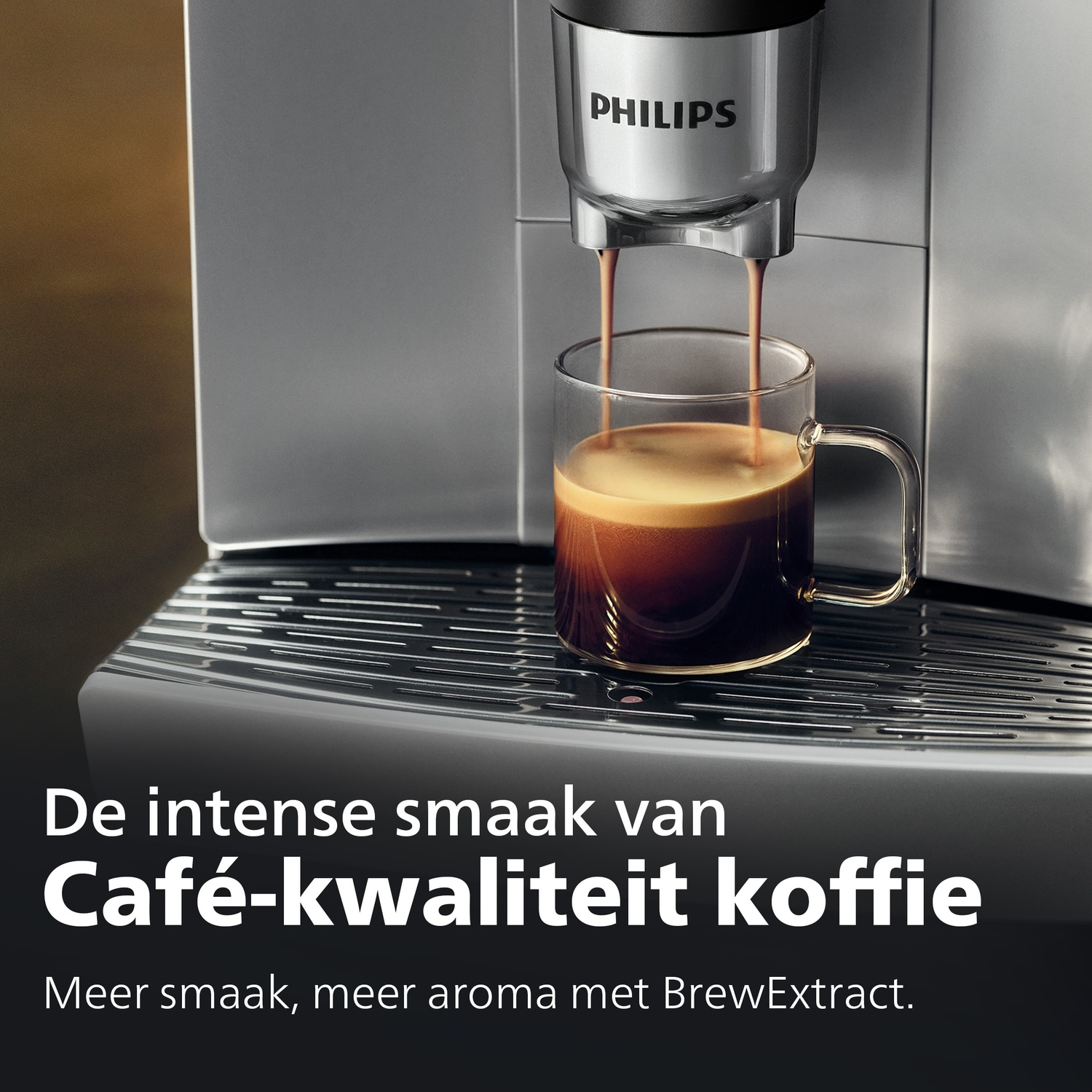 A Philips coffee machine brews coffee into a clear glass cup on a silver drip tray.