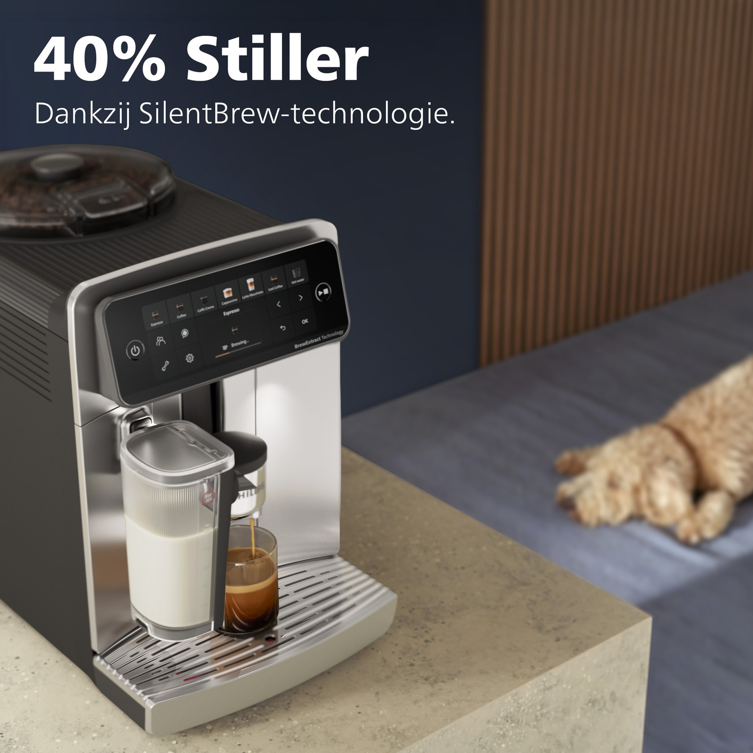 A black and silver coffee machine brewing espresso into a small glass on a kitchen counter, with a dog resting nearby.