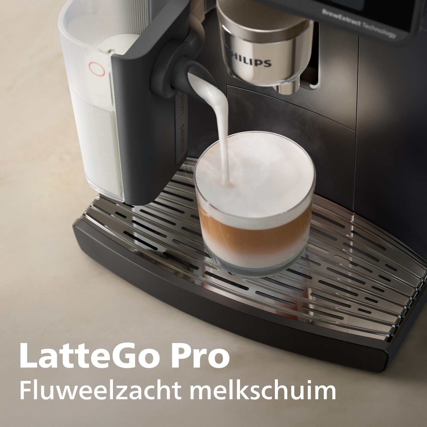 A coffee machine pours milk into a glass of cappuccino on a stainless steel drip tray.