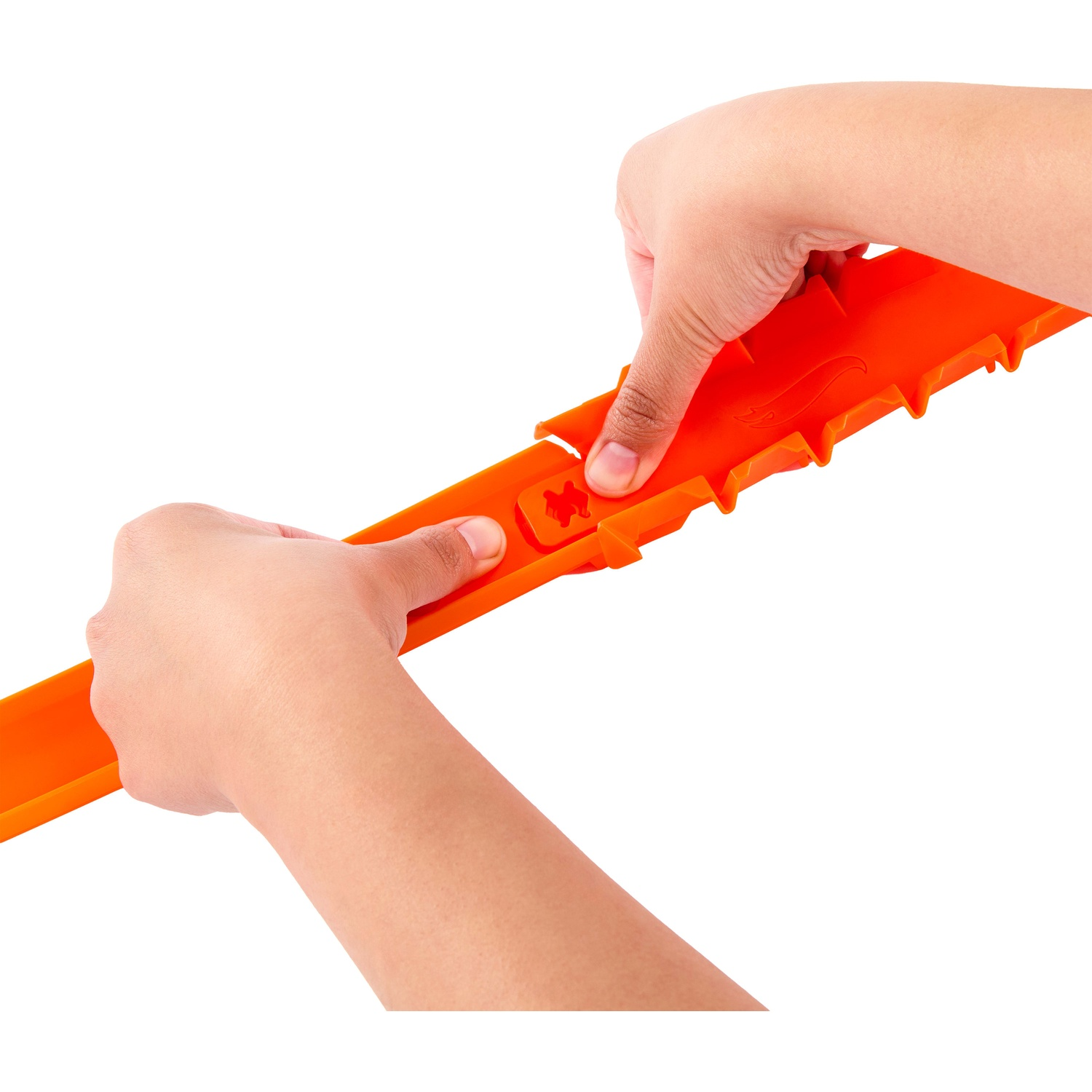 Hands connecting two orange toy car track pieces against a white background.