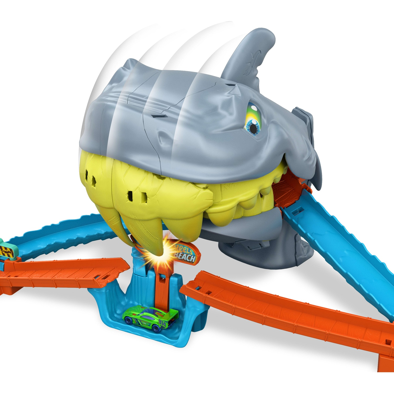 A gray shark toy track set snaps at a green toy car, surrounded by orange and blue tracks.