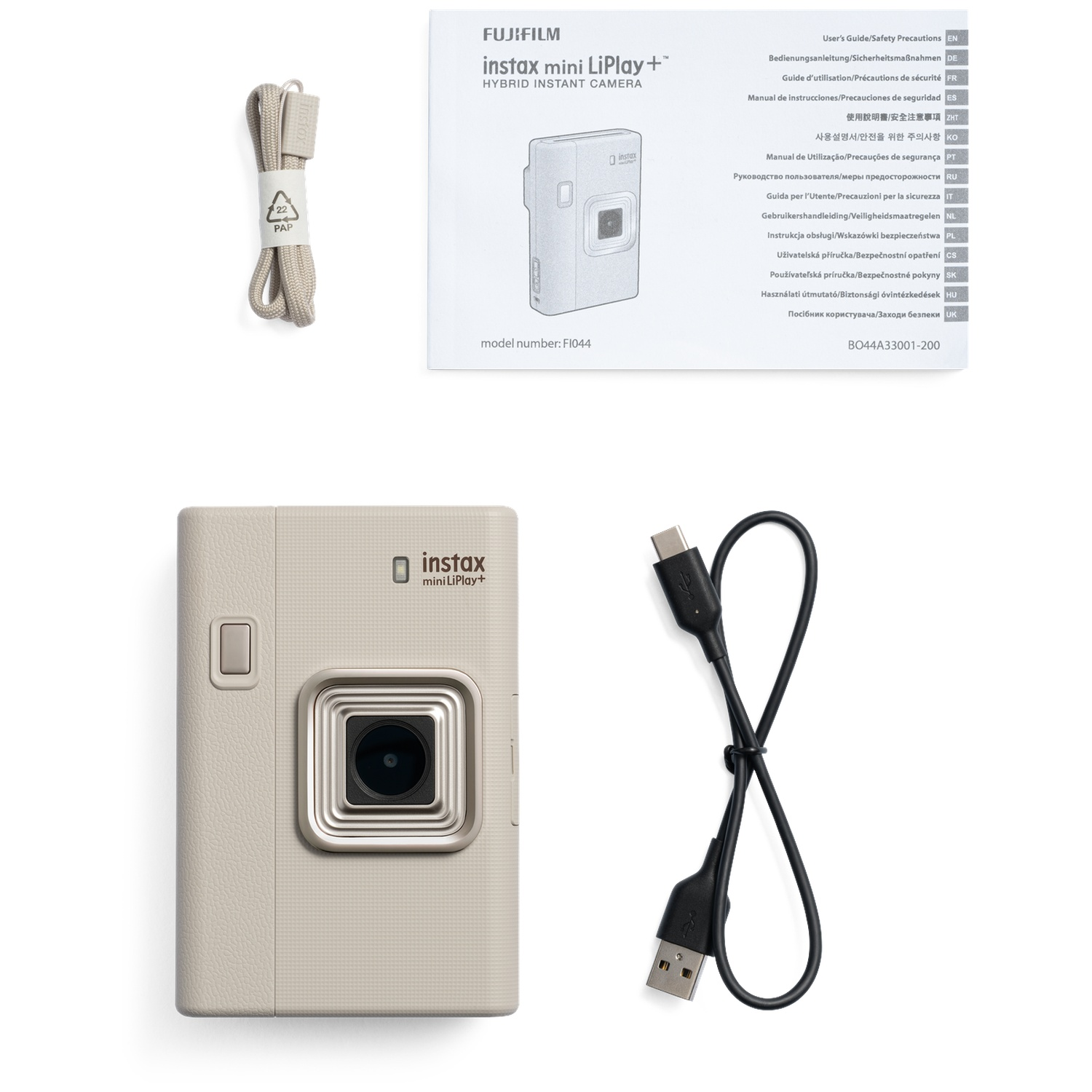 Caméra Instax mini LiPlay beige, sangle, câble USB et manuel sur fond blanc.