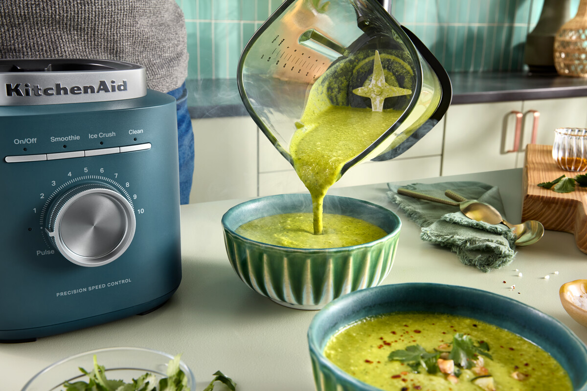 Grüne Suppe wird aus einem KitchenAid-Mixer in eine Schüssel gegossen.