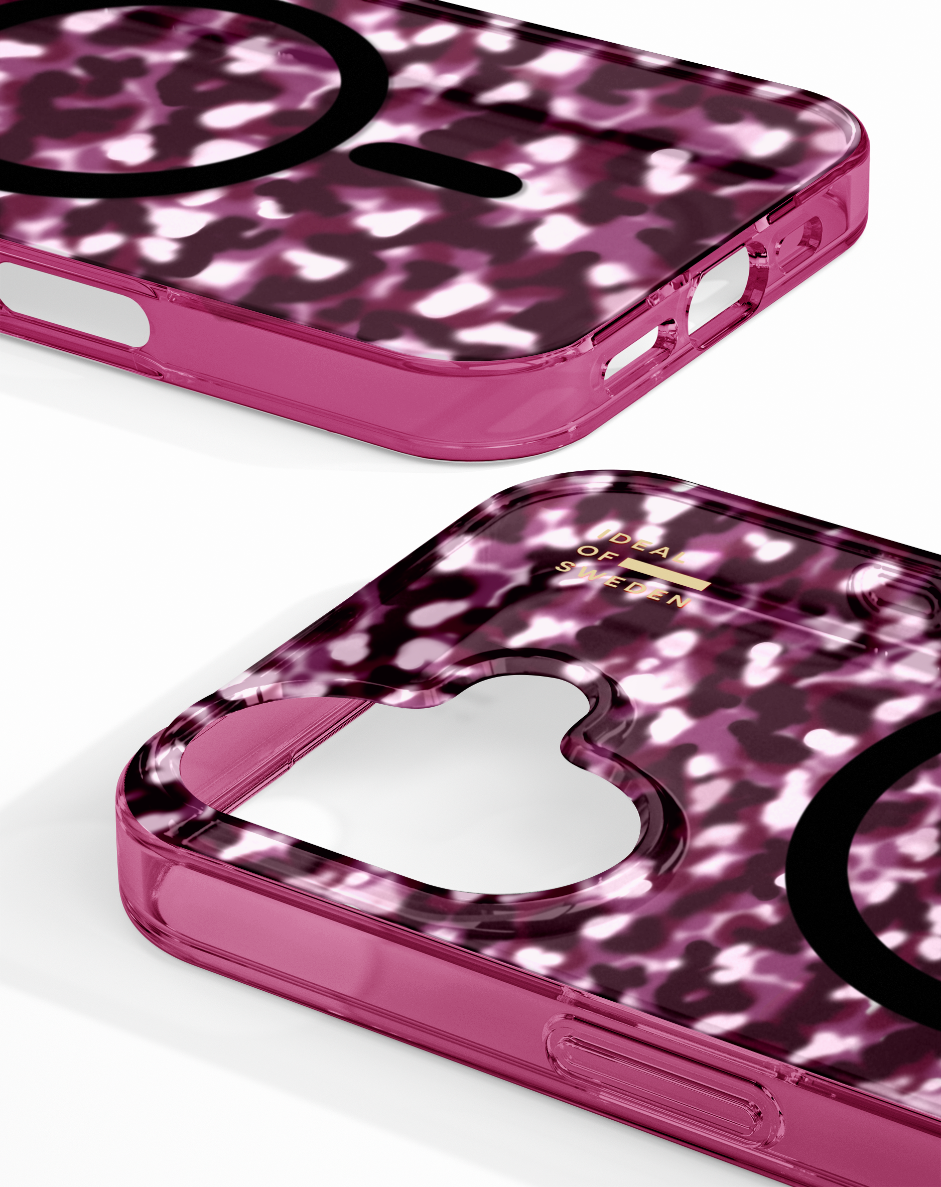 Zwei pinke Handyhüllen mit weißem Fleckenmuster und schwarzem MagSafe-Ring auf weißem Hintergrund.