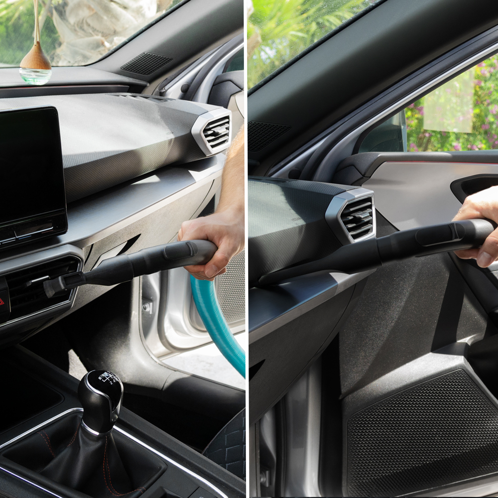 Una persona limpia las rejillas de ventilación y el interior de un coche con una aspiradora.