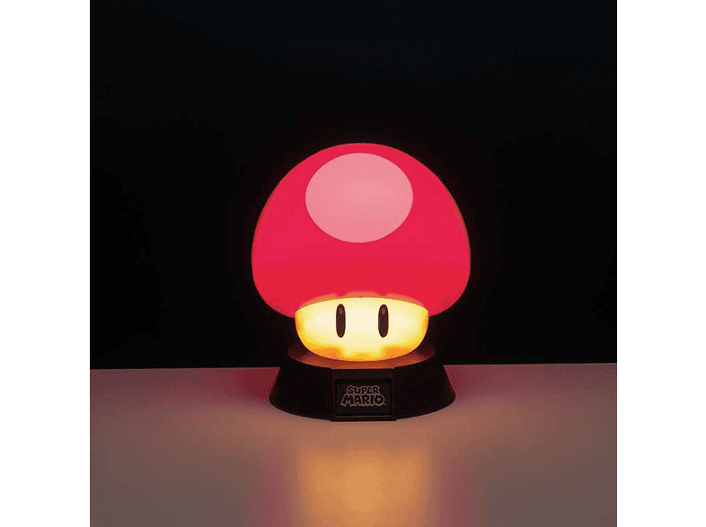Una lámpara de hongo de Super Mario roja y blanca brilla sobre un fondo oscuro, en una base negra con texto.