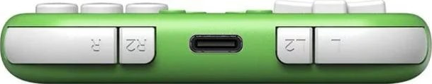 La parte superiore di un gamepad verde con pulsanti dorsali bianchi e una porta USB-C centrale.