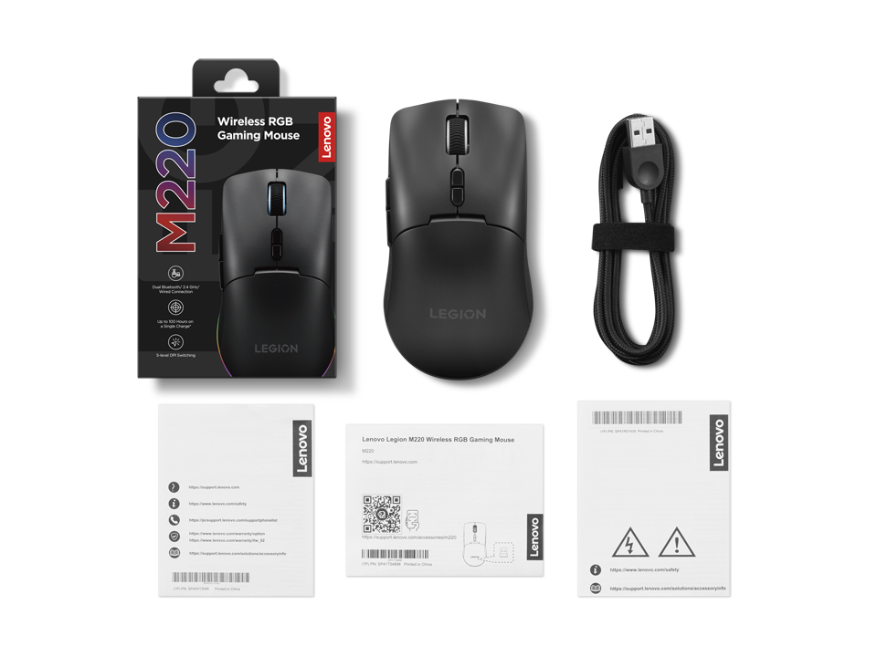 Ratón inalámbrico RGB Lenovo Legion M220 con embalaje, cable USB y manuales sobre un fondo negro.