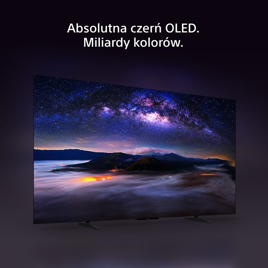 Telewizor OLED wyświetla żywe nocne niebo z górami nad chmurami, pod polskim tekstem.