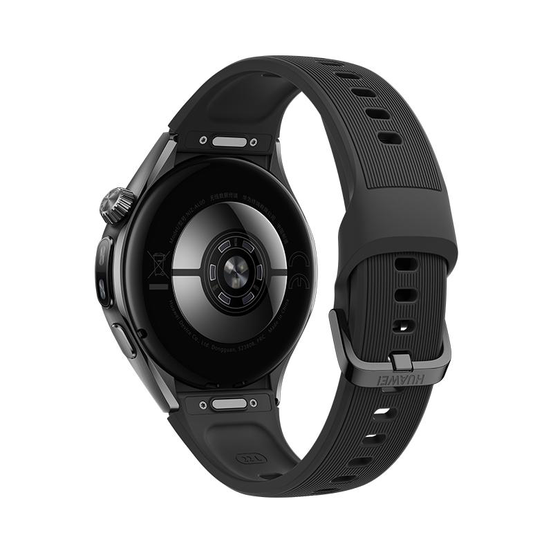Nahaufnahme der Rückseite einer schwarzen Smartwatch mit Sensoren und geripptem Armband vor neutralem Hintergrund.