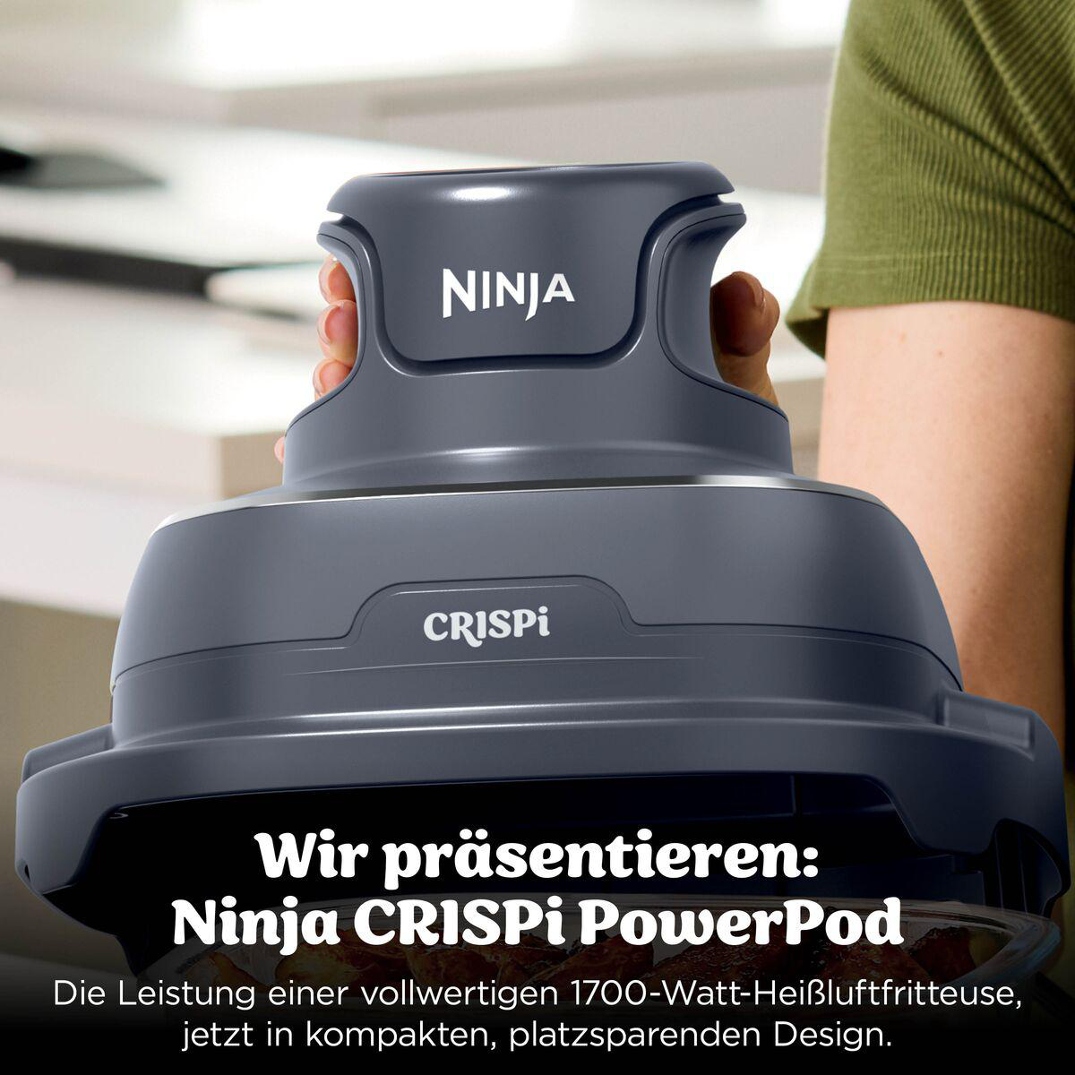 Grauer Ninja CRISPi PowerPod in Händen gehalten, mit Text im Vordergrund.