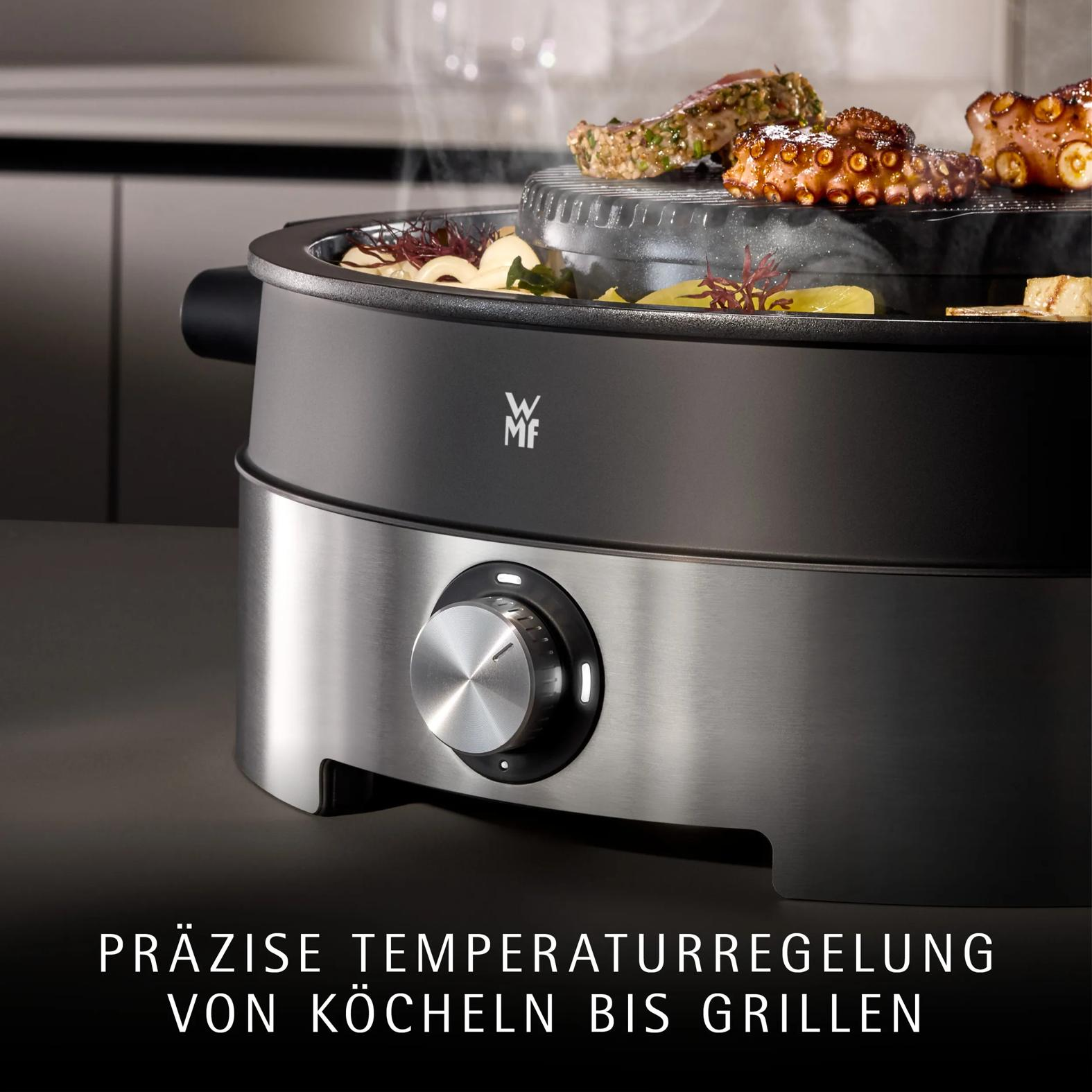 Ein WMF-Grill kocht Fleisch und Gemüse mit Dampf. Darunter befindet sich ein Temperaturregler.