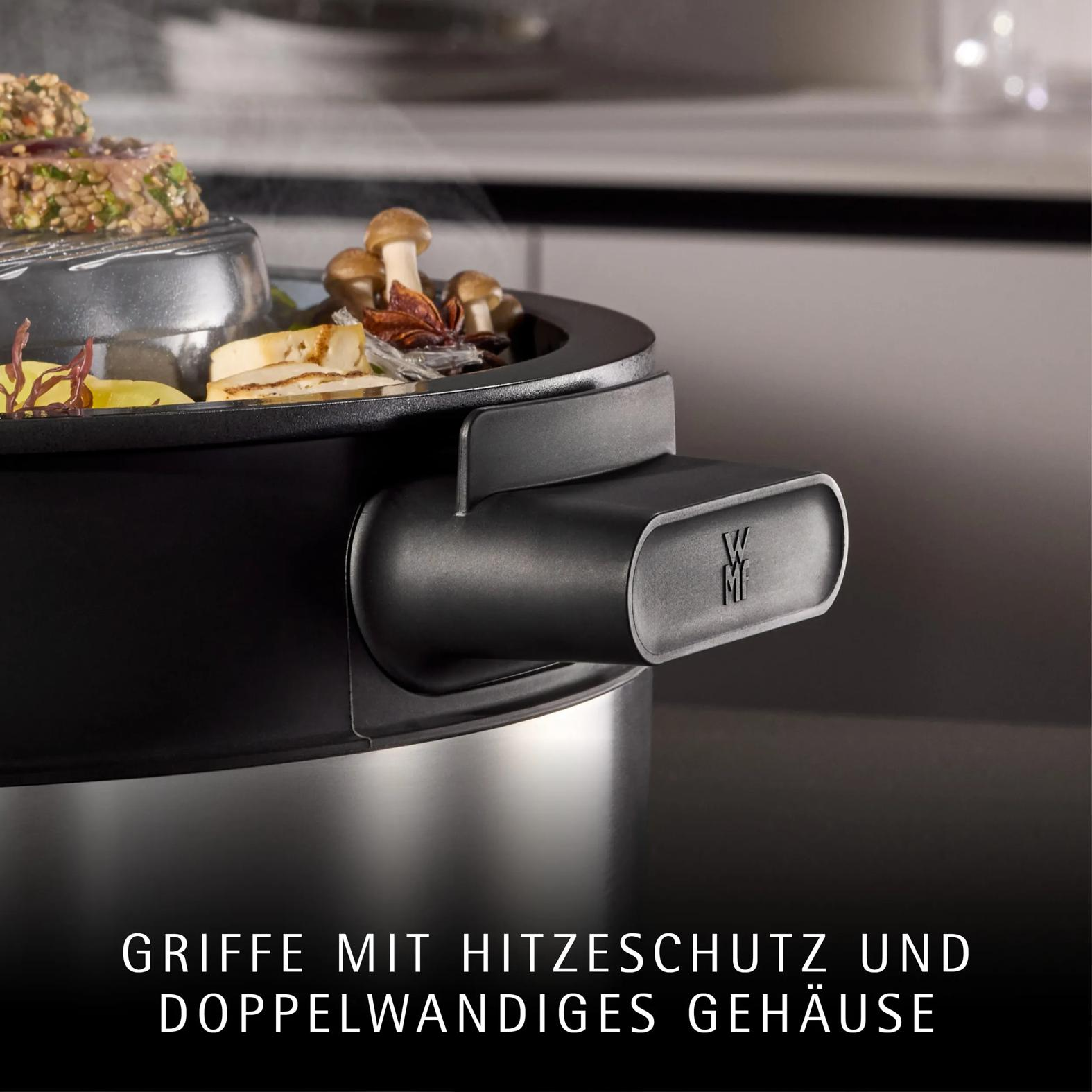 Close-up of a modern electric cooker with a black heat-resistant handle and steaming food.