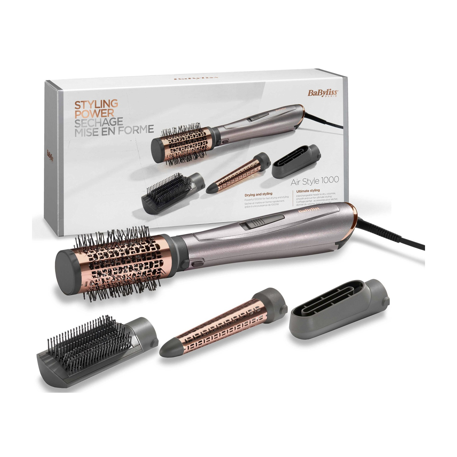 Styler ad aria calda grigio e oro rosa con tre accessori e la sua confezione su sfondo bianco.