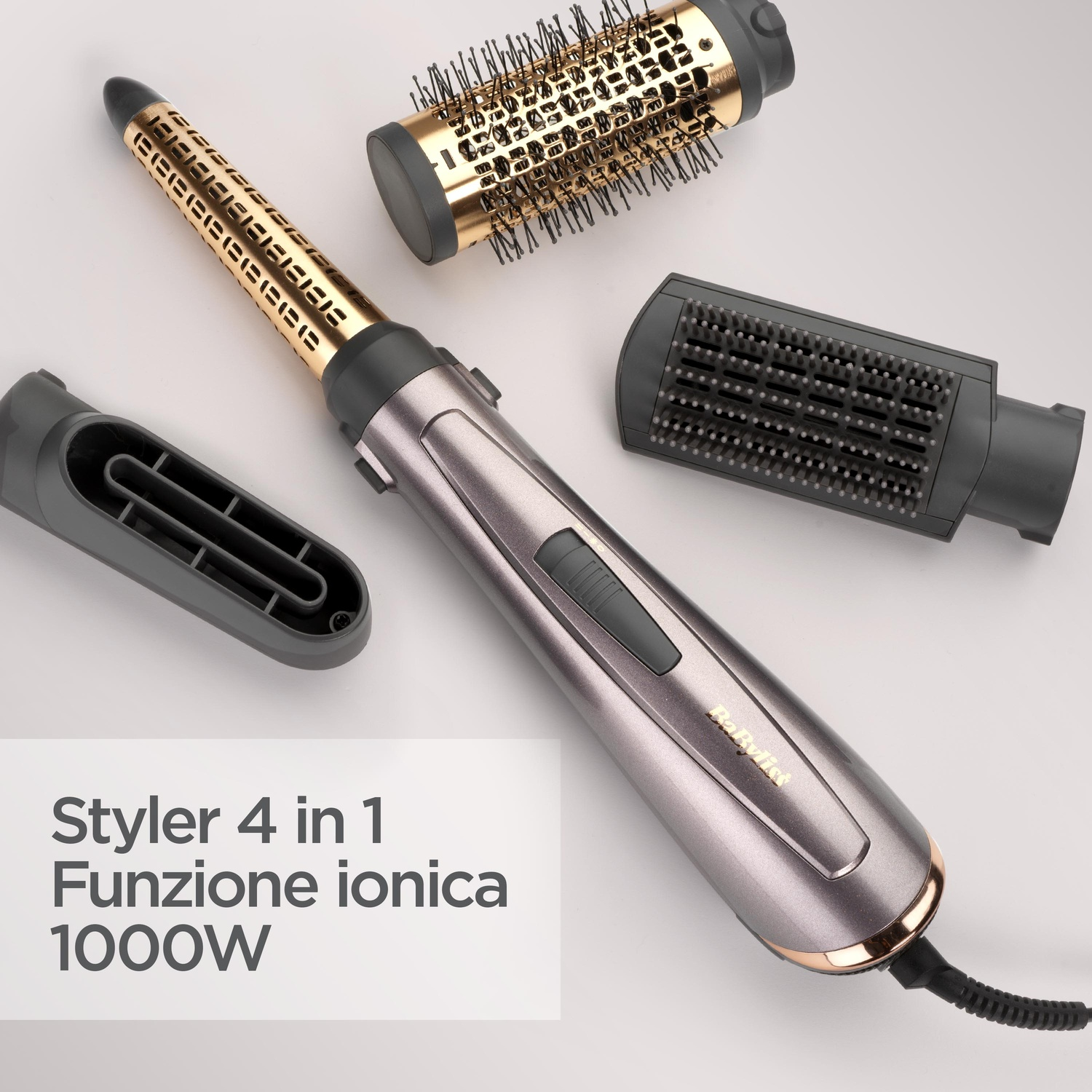 Styling per capelli BaByliss 4 in 1 con manico grigio e oro e tre accessori su sfondo chiaro.