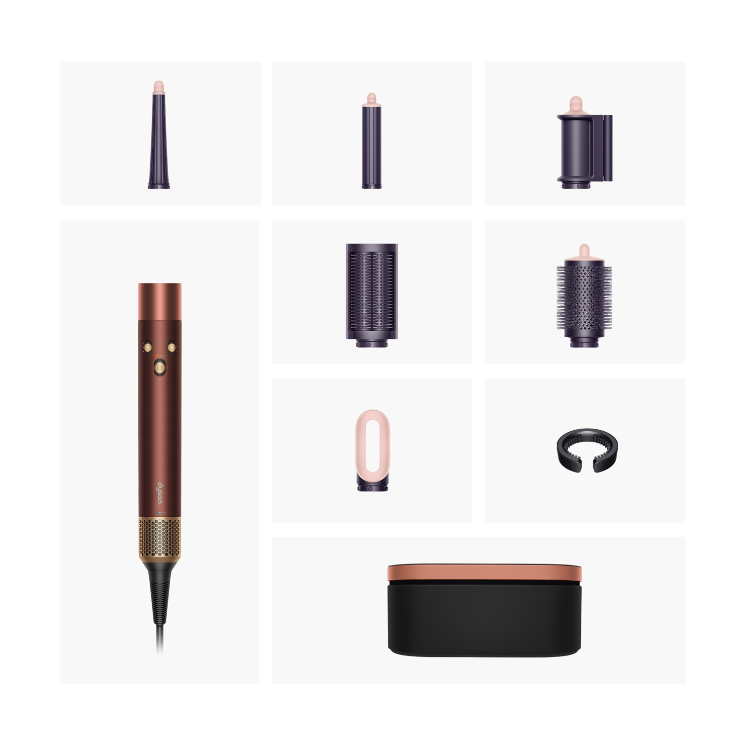 Styling Dyson in rame e oro rosa con vari accessori e scatola su sfondo bianco.